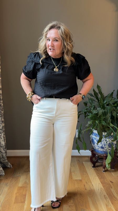 Blouse size large 
Jeans size up to larger size! I’m
Wearing a 15(32) jeans by a favorite affordable denim brand Risen

Classic white and black. The jeans are a vintage ecru white. So on trend! 

Summer outfit black blouse ecru jeans risen jeans 