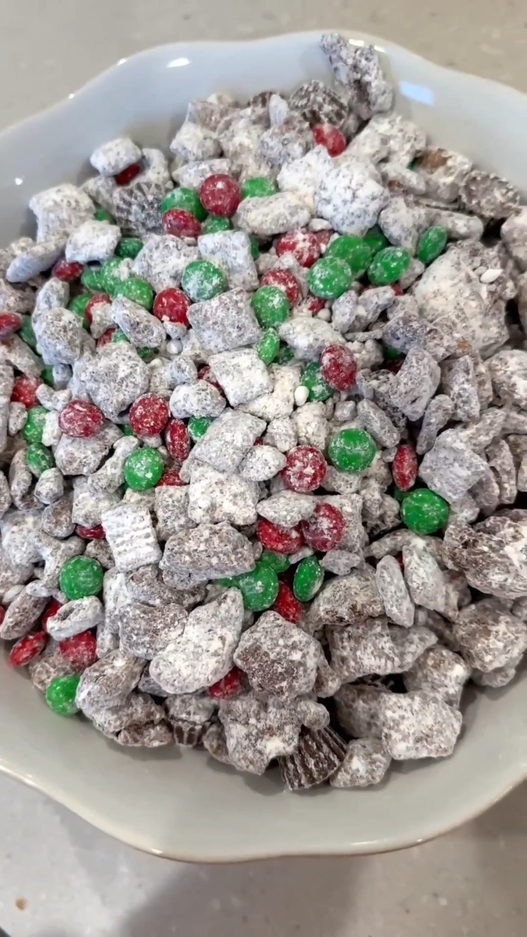 Make Reindeer food with me! My favorite little Christmas treat 🎅🏻🦌 This also makes an easy cute little gift as well 🎁 I linked the containers that you can use for that as well! 
Recipe
• 1 ½ cups semisweet or dark chocolate chips
• 1 ½ cups creamy peanut butter
• 5 cups Rice Chex Cereal
• 1 ½ cups mini pretzels broken into pieces
• 2 cups powdered sugar
• 1 ½ cups red and green M&Ms
• 1 cup mini peanut butter cups

In a large bowl, combine rice Chex cereal and pretzel pieces.
Melt peanut butter and chocolate together, either on the stovetop or in the microwave.
Pour peanut butter chocolate mixture over cereal/pretzel mixture and stir to combine.
Chill in the refrigerator until the mixture just barely begins to set up (about 30 minutes).
Remove the mixture from the refrigerator.
In a separate, large bowl, put ½ cup powdered sugar on the bottom of the bowl. Add half of the chilled mixture, then add another ½ cup powdered sugar over the cereal and the remaining chocolate/cereal mixture.
Gently stir until the powdered sugar is evenly distributed, tossing to coat the cereal with powdered sugar.
Chill the mixture again in the refrigerator until it’s set (about another 30-60 minutes).
Add more powdered sugar, ¼ cup at a time until the cereal/pretzel mixture is coated.
Add M&Ms and peanut butter cups and stir to combine.
Transfer to a serving bowl and serve.

Reindeer food recipe, Christmas treats, Christmas party ideas, Christmas gift ideas, Christmas party favor


#LTKSeasonal #LTKfoodie #LTKHoliday