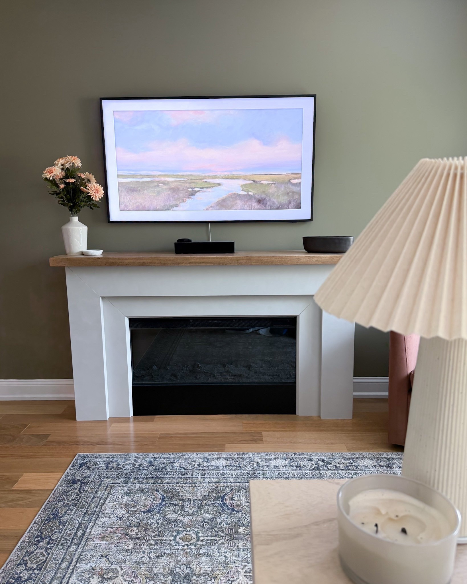 This Pottery Barn fireplace is the focal point of the space, framed by a vintage-style Amazon rug and cozy swivel chair. The Samsung Frame TV blends in as art, making the whole wall feel intentional. It’s my favorite living room refresh yet.

#LTKStyleTip #LTKOver40 #LTKHome
