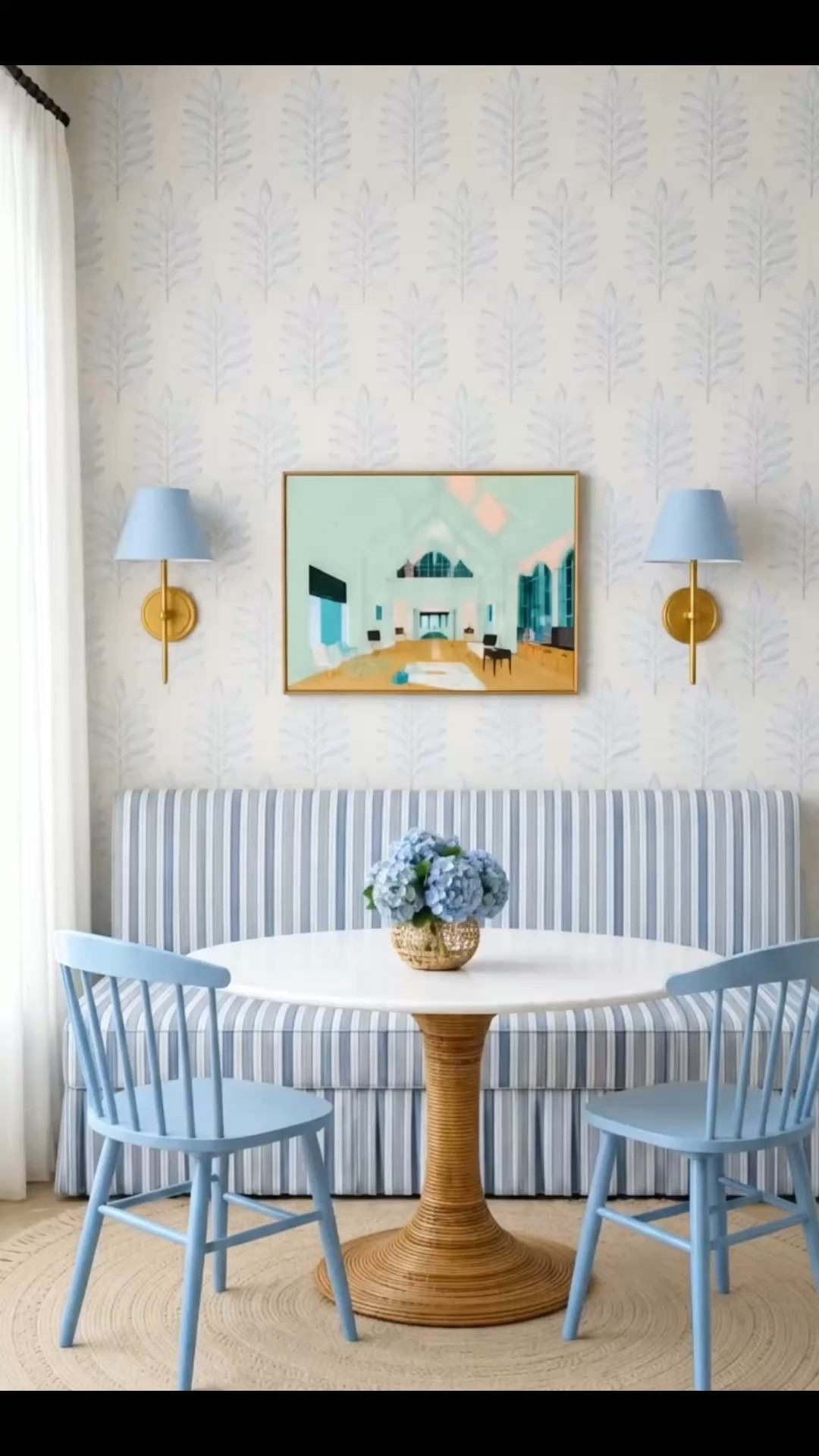 One of my favorite ways to start the day. ☀️ Just imagine yourself sitting here as the morning sun shines into this breakfast nook, filling the space with soft, natural light. It's peaceful, cozy, and the perfect spot for a slow morning coffee.

The striped dining bench gives the nook a timeless, tailored look, while this dining table is the true statement piece. I love how the handcrafted coiled natural rattan base showcases the beauty of raw materials, paired with a sophisticated marble top for the perfect balance of organic texture and refined elegance. It's relaxed, coastal, and effortlessly chic.

Many pieces are part of the 4th of July Sale, making it the perfect time to recreate this look.

#LTK #LTKSale #FourthOfJulySale #BreakfastNook #BanquetteSeating #DiningBench #DiningTable #MarbleTable #RattanFurniture #CoastalStyle #BlueAndWhiteDecor #JuteRug #Hydrangeas #Wallpaper #WallSconce #DiningRoom #InteriorDesign #ModernCoastal #SerenaAndLily

#LTKHome #LTKdayinmylife #LTKHome #LTKU