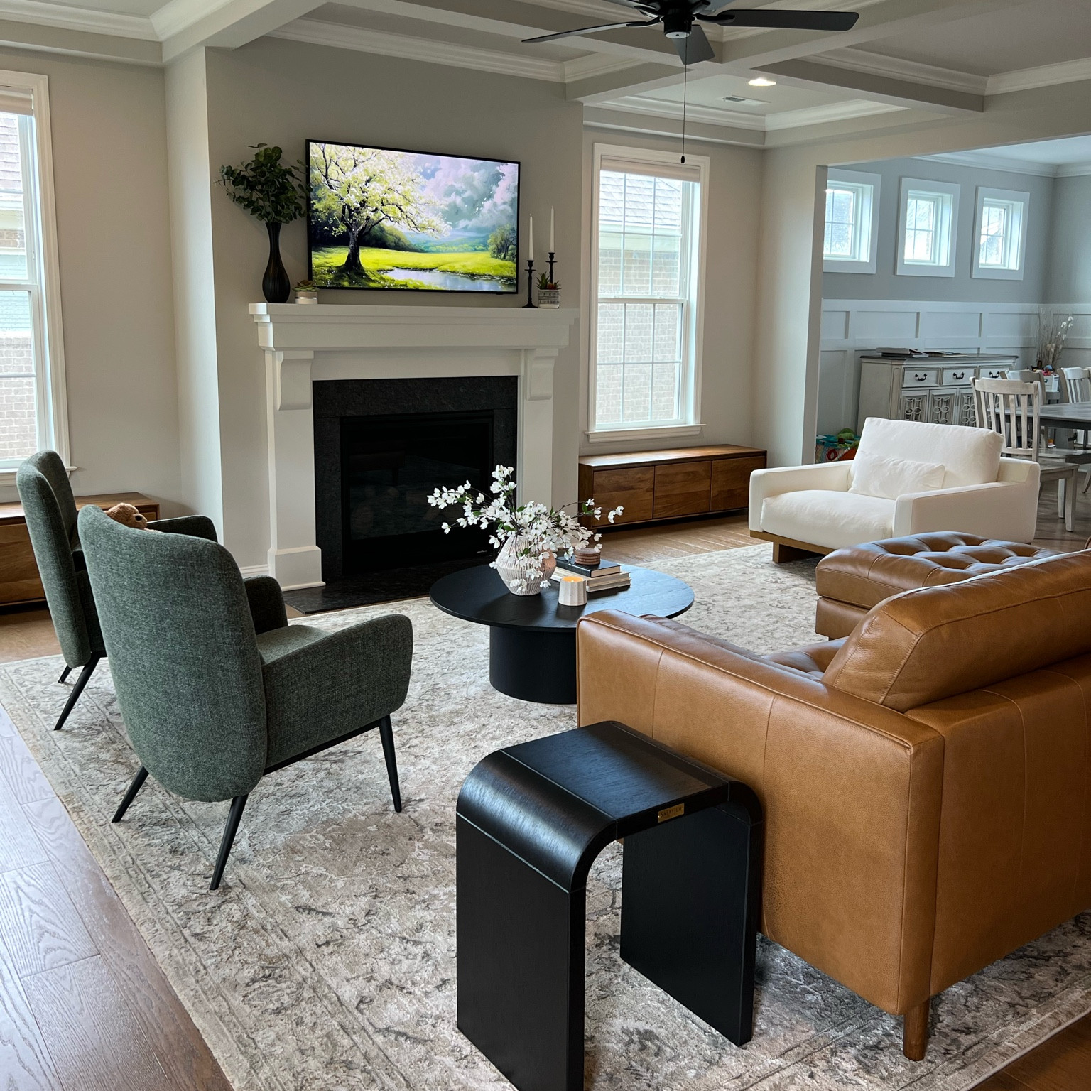 Modern living room decor, leather sectional, black modern side tables, green armchairs, performance fabric white accent chair, round coffee table

#LTKhome #LTKkids #LTKfamily