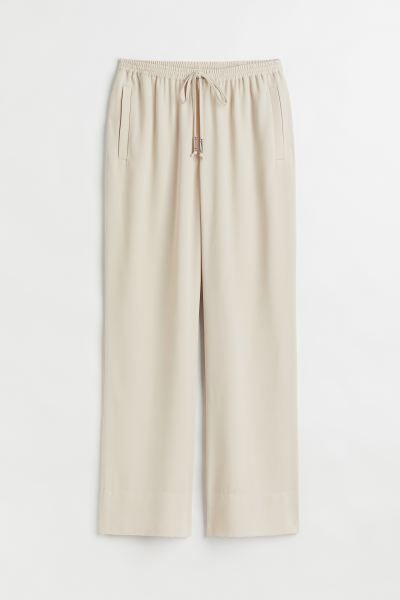 Conscious choiceTrousers in woven fabric with a high, elasticated, drawstring waist, side pockets... | H&M (UK, MY, IN, SG, PH, TW, HK)