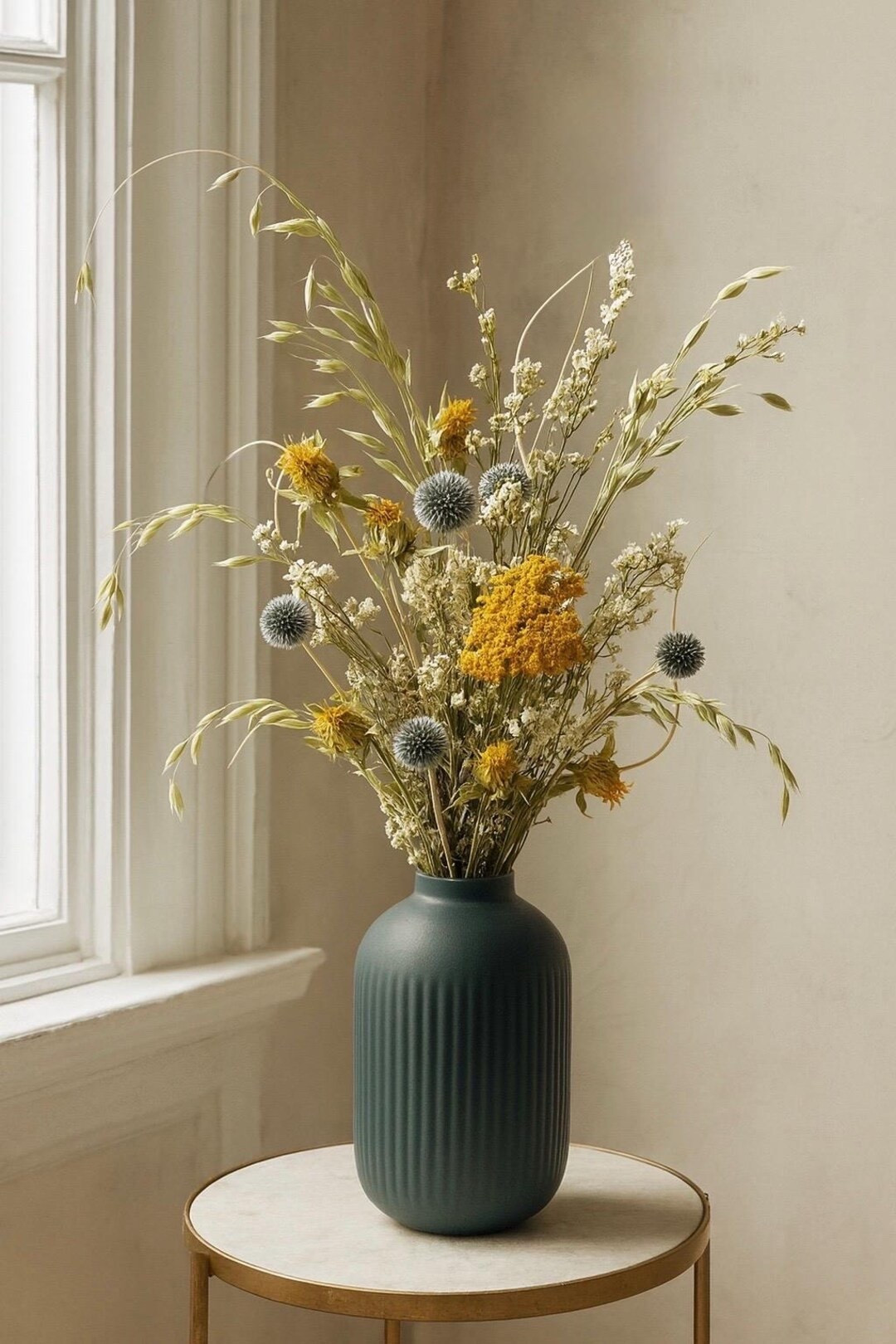 Full of texture and natural movement 🌾 This all-natural dried bouquet pairs golden yarrow and safflower with striking blue echinops, airy oats, and soft artemisia for a beautifully balanced, meadow-inspired look. Delicate nigella pods add a whimsical finishing touch, creating an arrangement that feels both earthy and refined. A timeless, long-lasting piece that brings effortless warmth and organic charm to any space.
#LTKHome #DriedBouquet #NaturalDecor #EverlastingFlowers #EtsyFinds #MeadowStyle #SustainableDecor #FloralInspo

#LTKFindsUnder50 #LTKSeasonal #LTKHome