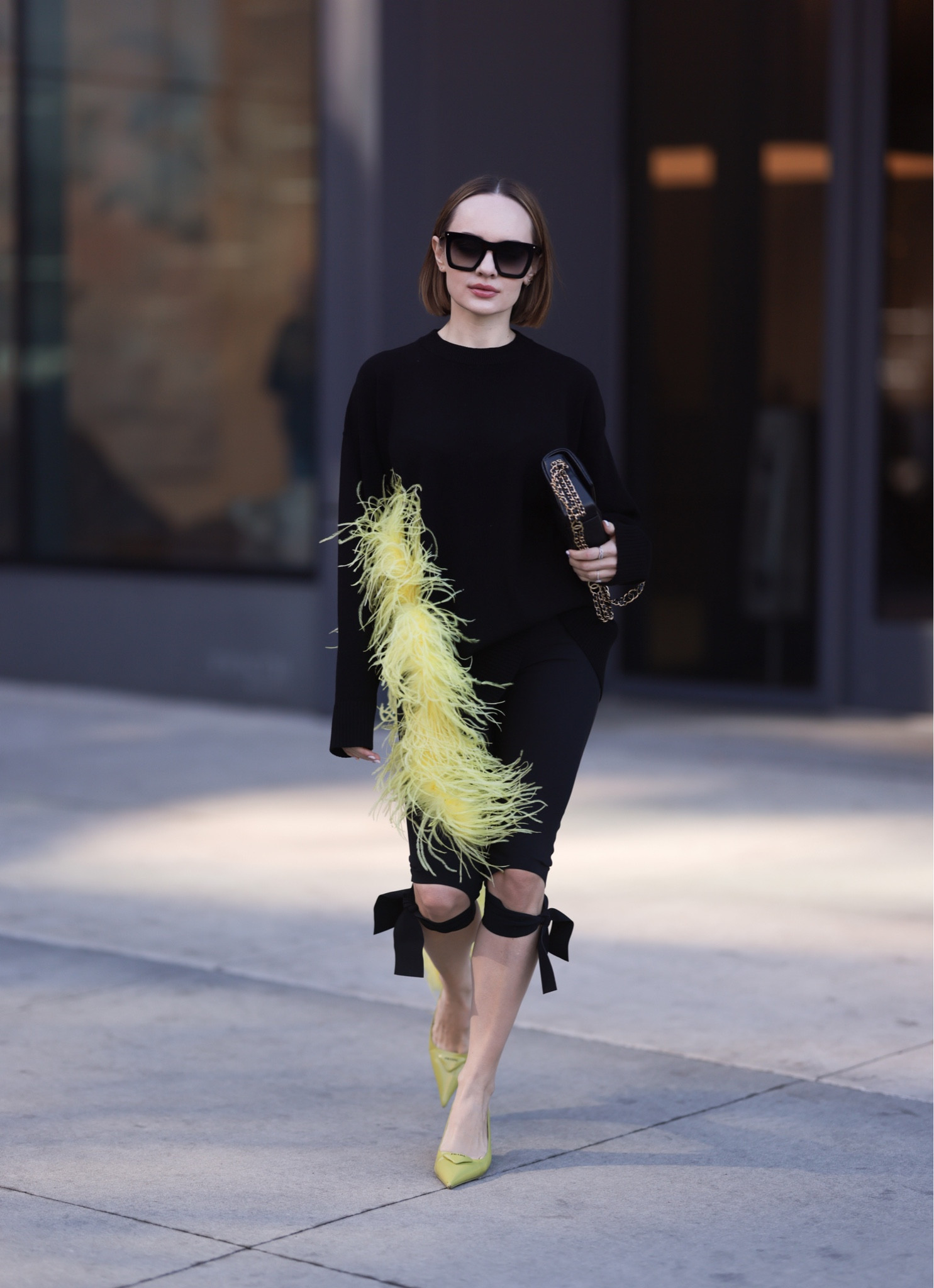 Black sweater with a yellow feather detahello

#LTKshoecrush #LTKFind #LTKstyletip
