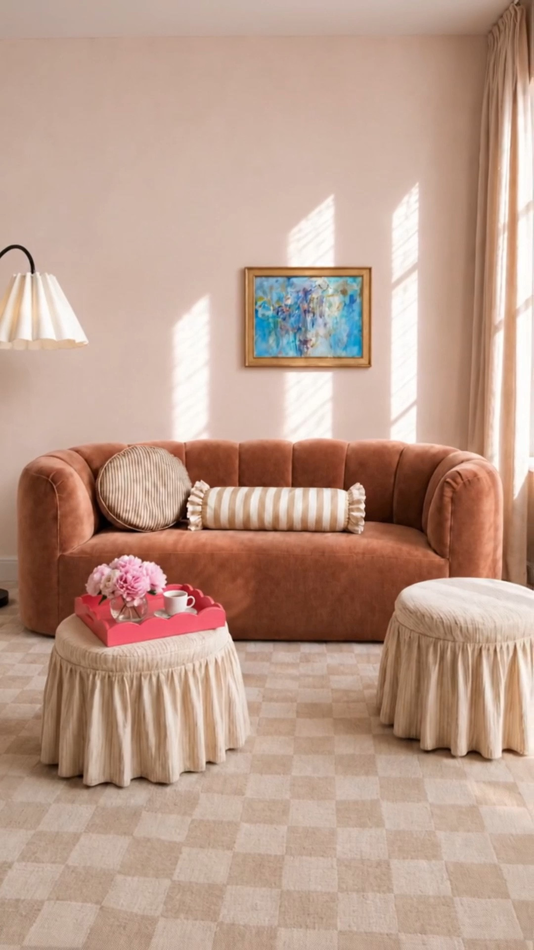 A serene coffee moment before the new day begins. Soft morning light washes over the curved channel-tufted sofa, creating a calm little corner to pause, breathe, and ease into the day.

The chic checkered rug adds playful pattern, while the striped ruffled ottomans and pillows bring softness and a relaxed feminine touch. I love how the watermelon-pink tray introduces a fresh pop of color, beautifully balanced by the touch of blue in the artwork. Finished with an elegant floor lamp and softly draped curtains, this space feels quiet, polished, and effortlessly inviting.

#CurvedSofa #Luxe #ChanneledSofa #RuffledOttoman #StripePillow #Art #FloorLamp #Tray #CheckeredRug #Drape #CoffeeMoment #SereneMorning #MorningLight #LivingRoomStyle #ModernClassic #LTKHome

#LTKdayinmylife #LTKHome #LTKSaleAlert