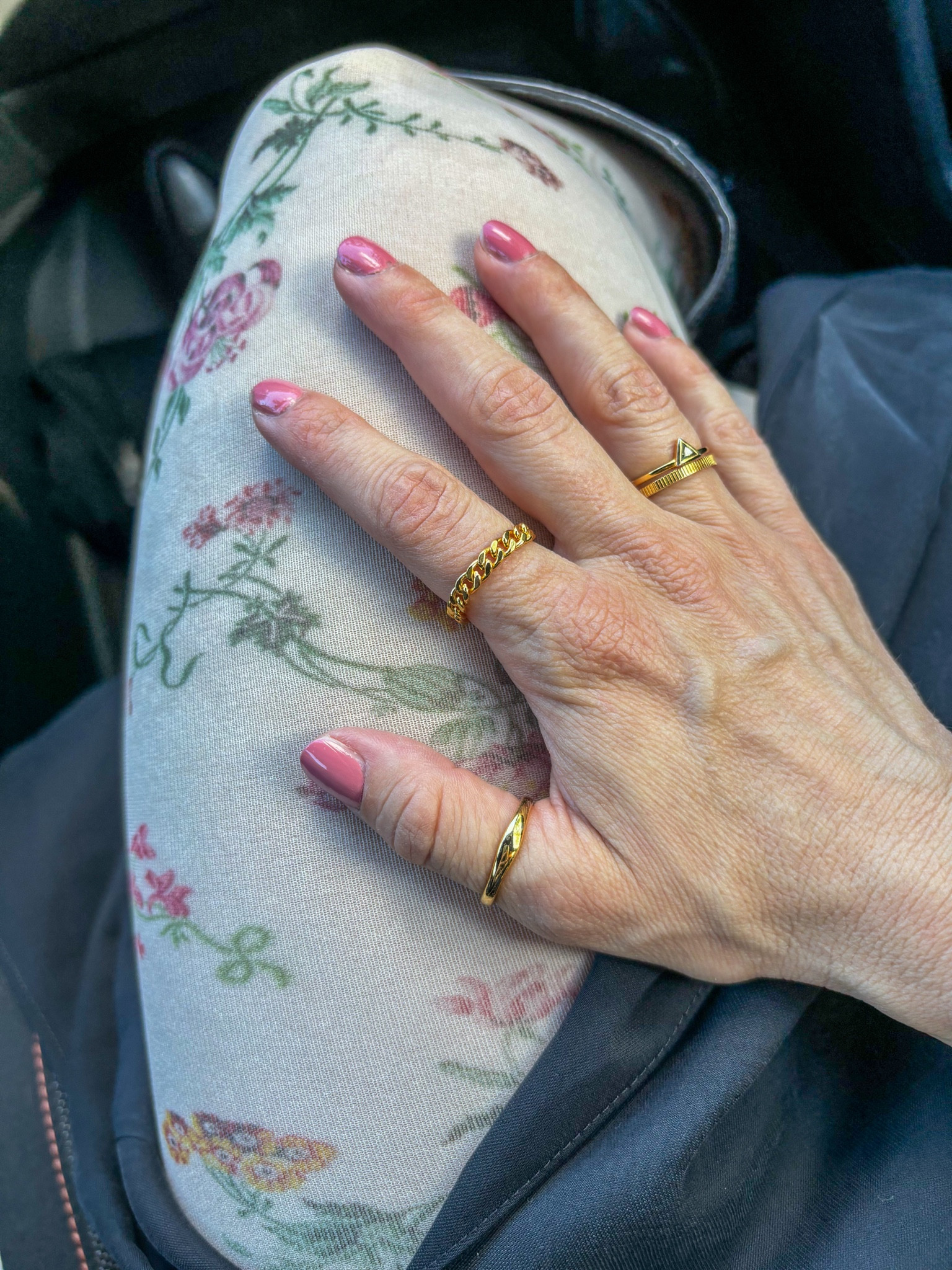 Floral printed tights and minimalist jewelry, stacking rings