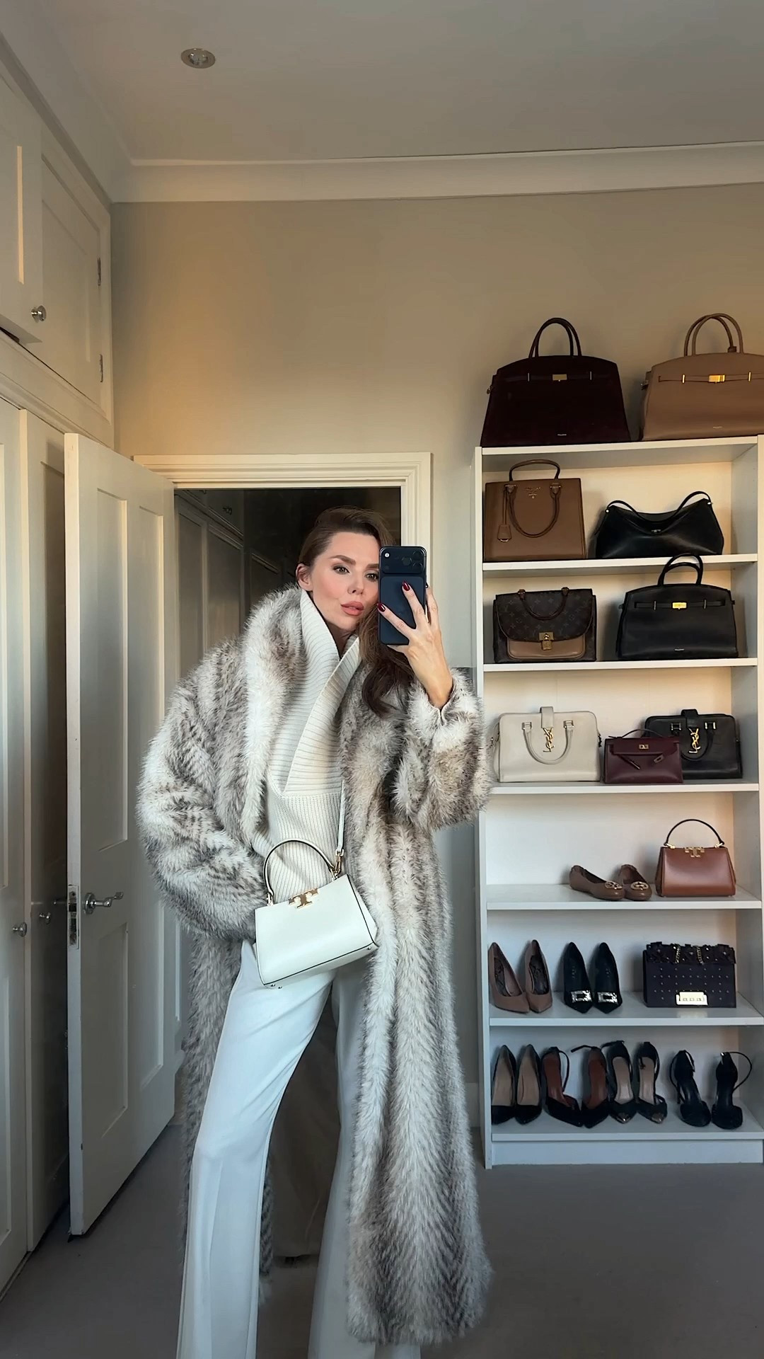 A cream V-neck jumper from H&M tucked into ivory River Island trousers for a clean, elegant winter look. Layered with the beautiful Topshop faux fur coat from ASOS that instantly adds a touch of old-Hollywood glamour. Finished with the Tory Burch ivory mini Eleanor satchel and ivory Paris Texas knee-high boots with a stiletto heel. Soft, polished, and effortlessly expensive.

#LTKfestive #LTKuk #LTKwinter