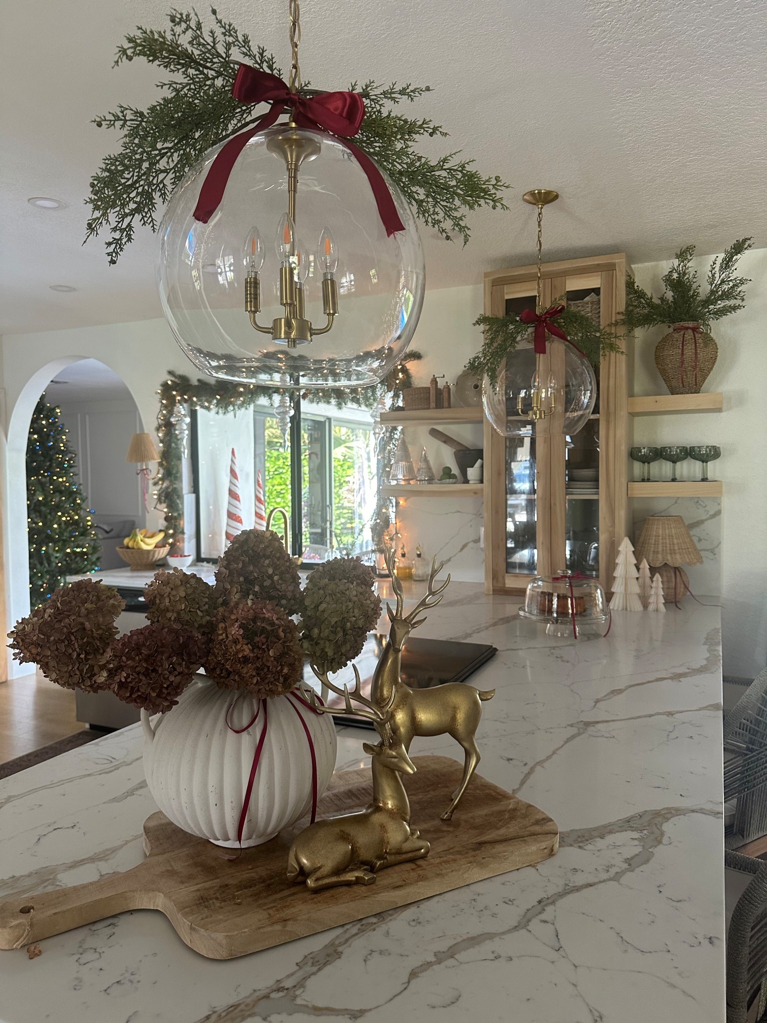 Christmas kitchen island and chandelier! Love adding this festive touch to our island and pendant lights. The red bows bring everything together. Winter Stems are from Hobby Lobby. 

Garland 
Winter stems 
Now
Red now 
Vintage Christmas 
Kitchen Christmas 
Pottery barn 
Walmart 
Target
McGee and co 
Magnolia 
My Texas house 
Reindeer 
Holiday 
Kitchen 

#LTKHome #LTKSaleAlert #LTKFindsUnder50