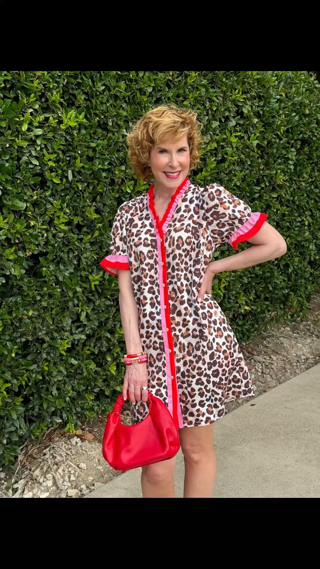 This lightweight leopard-print dress is such a fun way to lean into fall colors while the weather is still saying summer. I paired it with red strappy sandals, a coordinating handbag, and colorful bracelets. The breezy shift fit and playful ruffle trim make it comfortable, flattering, and easy to dress up or down.

#LTKootd #LTKSeasonal #LTKOver40