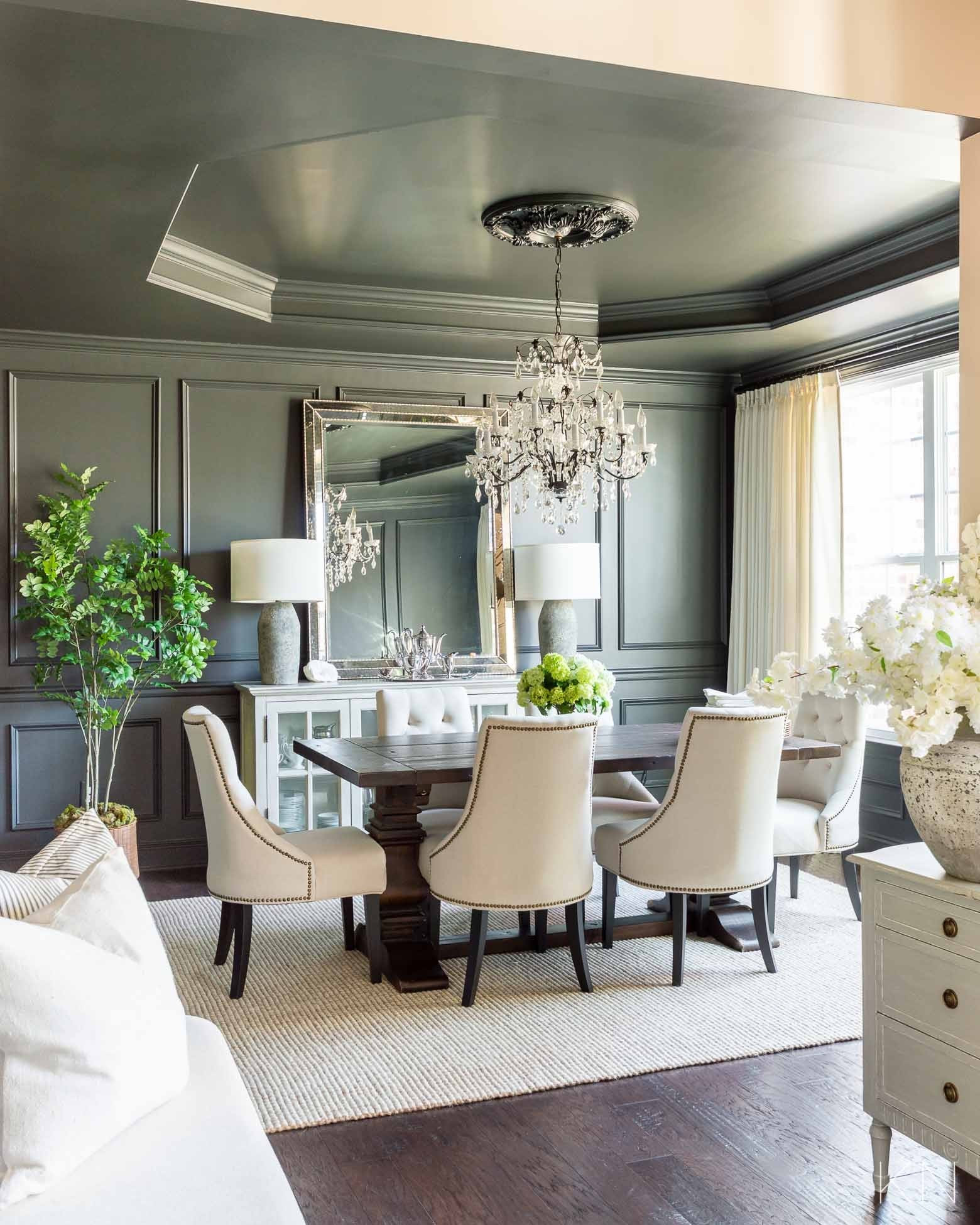 Here’s proof that just a paint color change can make a major difference to a room without having to toss away your furnishings. We went from light blue walls to Iron Ore walls and ceiling in the dining room and were able to keep the crystal chandelier, dining table, chairs and sideboard the same. home decor dining room decor wool jute rug cement lamp moody dining room

#LTKHome