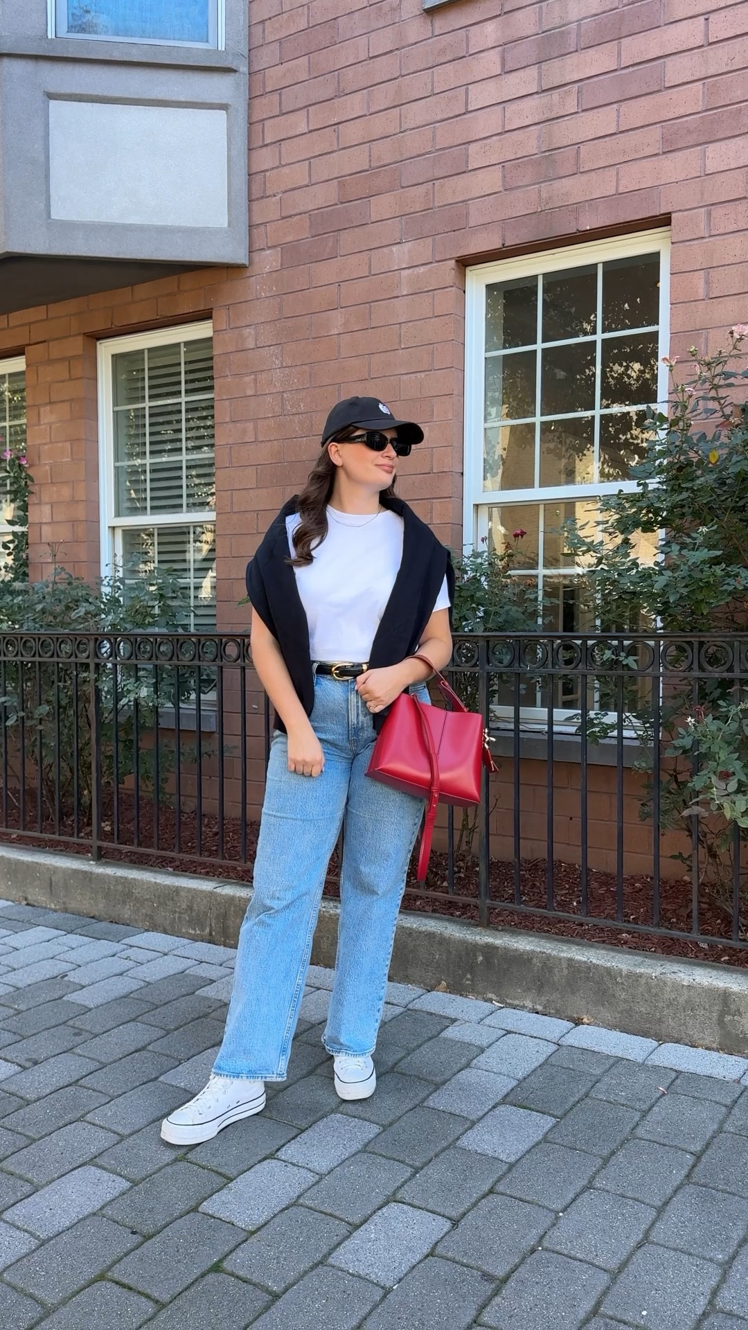 Sometimes a simple pairing of jeans and a plain white t-shirt is all you need as the base of your outfit. I draped a black sweatshirt over my shoulders for when the temperatures dropped. I added a baseball cap and my platform Converse sneakers to keep it casual but then grabbed my red purse for a bit of a statement moment. 

#LTKShoeCrush #LTKSeasonal #LTKFindsUnder100