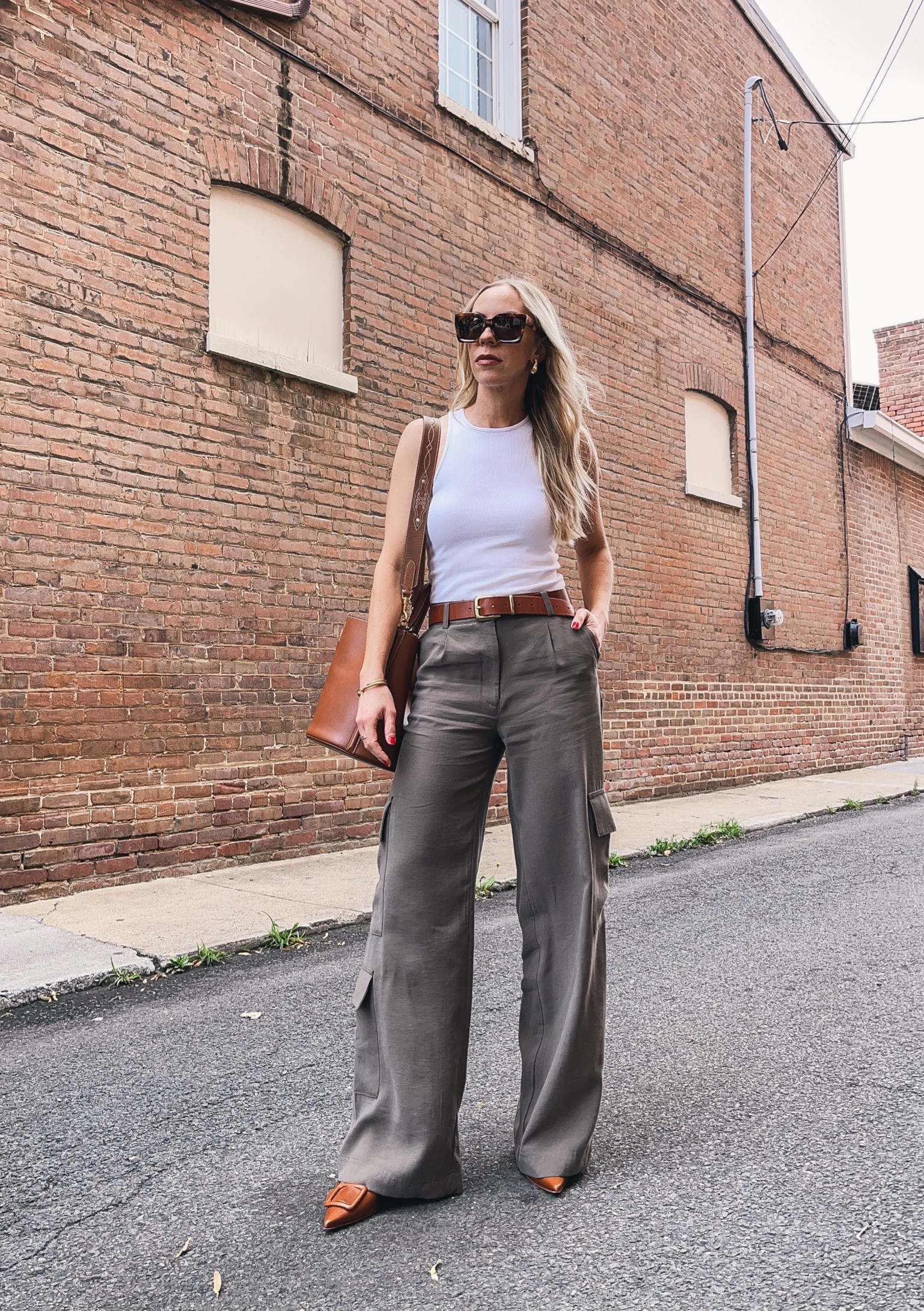 White tank top with wide leg cargo pants, olive green utility pants, Madewell leather belt, Celine bucket bag, transitional summer outfit 

#LTKunder100 #LTKstyletip #LTKunder50