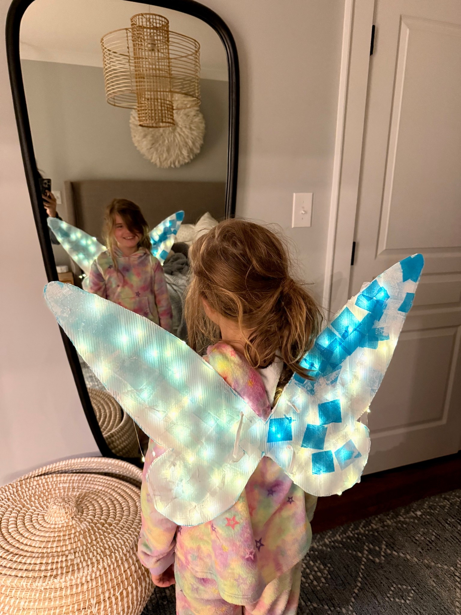 On one poster board I drew the wings with washable marker.
I then cut the wings out with scissors- a box cutter would be even better but I couldn’t find ours and our design wasn’t too intricate.

I poked holes where the elastic would go just to have that done and then maintained them as we used tissue paper and glue (easy to continue to poke thru).

We cut out tissue paper into squares.
Then we did a layer of plain modge podge and layered the squares onto the modge podge. We put a layer of sparkle modge podge on top of that.
Let that dry for about 30 min and then repeated on the other side.

After that we took our fairy lights and threaded them through the columns. We used 4 lights total- 2 on each wing. I made sure to start them through the bottom so the switches are all at the bottom and then we taped them up to the inside of the wings. Put about 4 or 5 columns between each. 

Then I thread the elastic through the small holes and knotted them. 

Ta-da! Homemade light up fairy wings 💙

