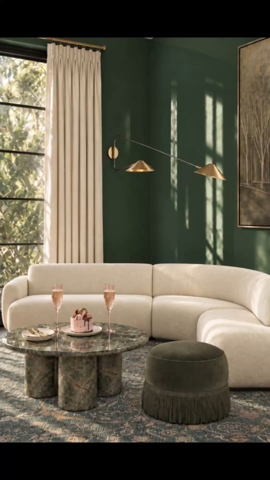 Happy hour at home 🍸 A cozy cocktail moment feels even better in a living room layered with rich color, sculptural curves, and warm late-afternoon light.

I love how the curved sectional softens the entire room and creates such an inviting place to settle in with a drink. The green marble coffee table brings incredible natural movement and character, while the richly patterned rug adds depth, warmth, and just the right contrast against the high-gloss green walls.

Finished with a fringed velvet ottoman, tailored drapery, brass wall sconces, framed art, pink drinkware, layered tabletop pieces, and a simple dessert moment, this corner feels chic, intimate, and ready for cocktail hour at home.

Arhaus is up to 50% off storewide right now—a great time to invest in pieces you love and refresh your living room for the gathering season.

#HappyHour #CocktailHour #CocktailMoment #HappyHourAtHome #LivingRoom #LivingRoomDesign #LivingRoomDecor #Sectional #CurvedSectional #CoffeeTable #MarbleCoffeeTable #AreaRug #Rug #Ottoman #Drapes #Curtains #WallSconce #Lighting #WallArt #Drinkware #Glassware #Tabletop #HomeDecor #InteriorDesign #ModernClassic #CozyHome

#LTKSeasonal #LTKHome #LTKSaleAlert