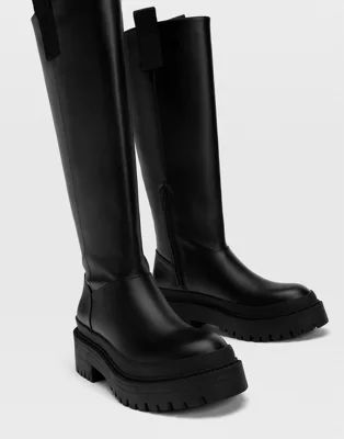 Stradivarius chunky sole high leg boots with side tab in black | ASOS (Global)