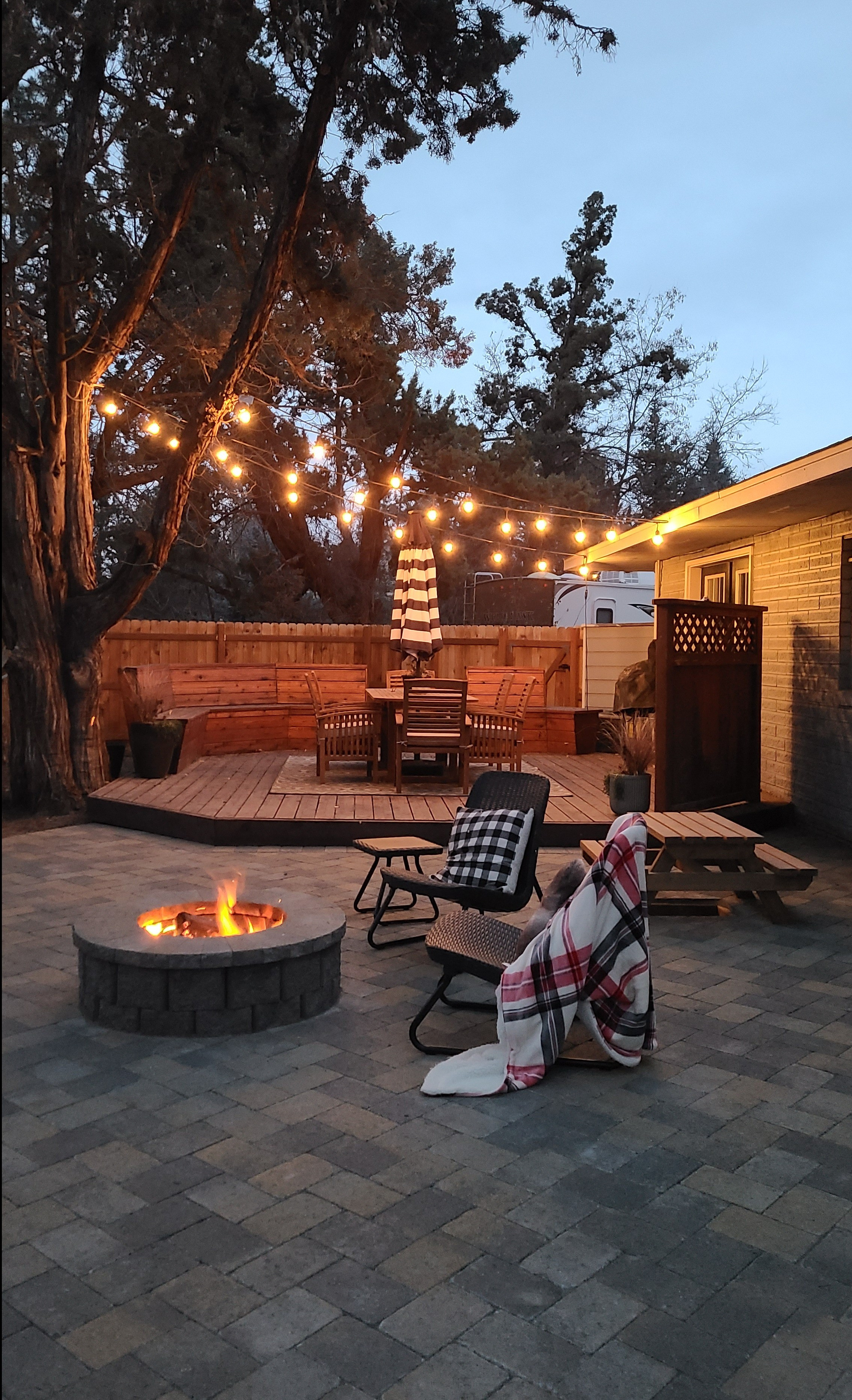 Such a cozy night in the backyard with a fire pit and string lights! #backyard #firepit  

 #LTKHome