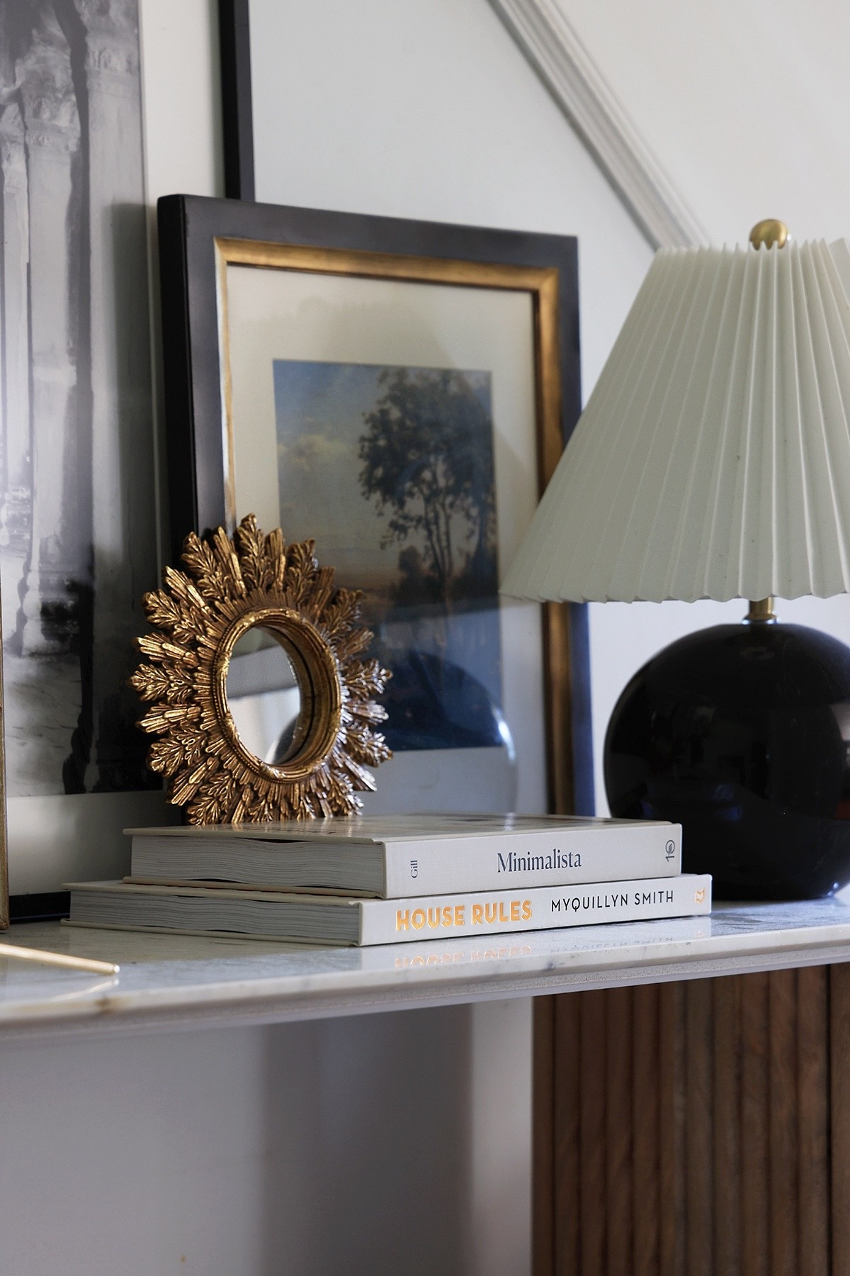 Style a console with a fluted lamp, small gold mirror, artwork, and a stack of home decor books

#LTKHome