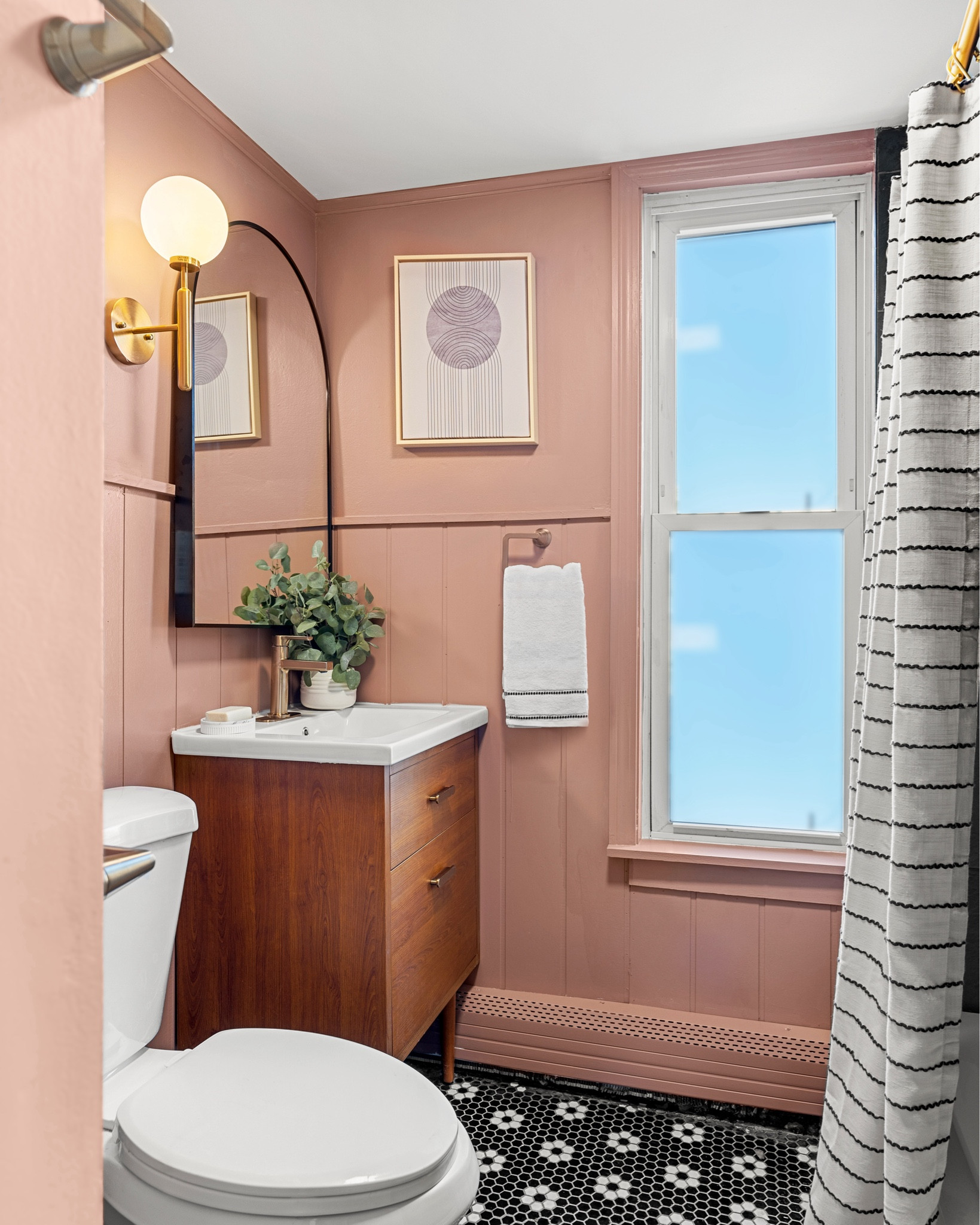 #AD and now it's time for the after! for this project, #dwelloctoberstudio teamed up with @loweshomeimprovement, exclusively using @loweshomeimprovement products to transform a bathroom for a local apartment owner, all on a budget. we were inspired by this beautiful mauve paint color. we applied vertical shiplap paneling to the lower half of the walls to add texture and visual interest. to balance out the pink, we opted for darker tones when selecting tile and vanity, then added a touch of brushed brass for warmth. #LowesPartner #dwelloctober 

#LTKFindsUnder100 #LTKHome #LTKFindsUnder50