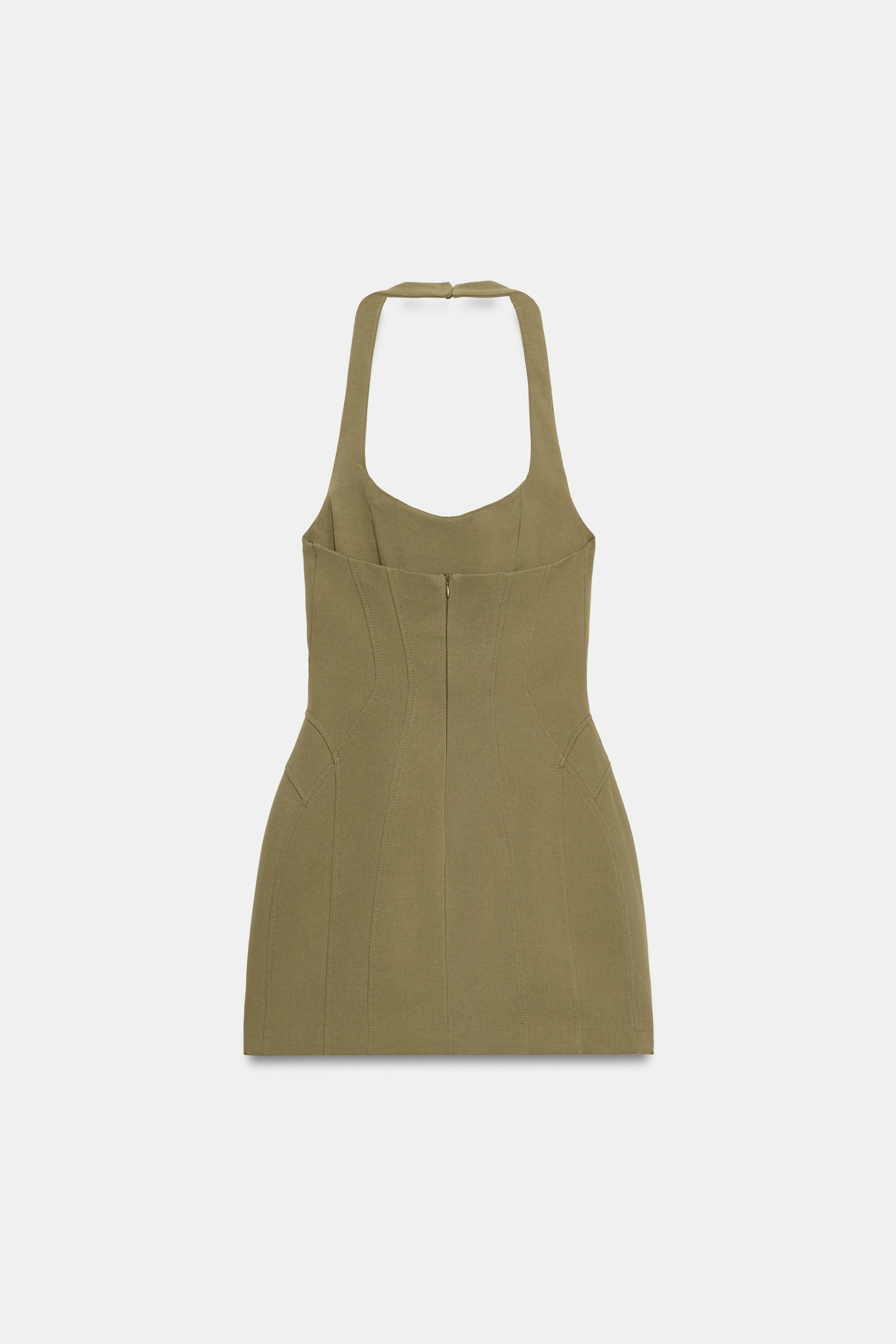 Short elastic halterneck dress with adjustable hidden buttons and round neckline. Featuring off-t... | Zara UK