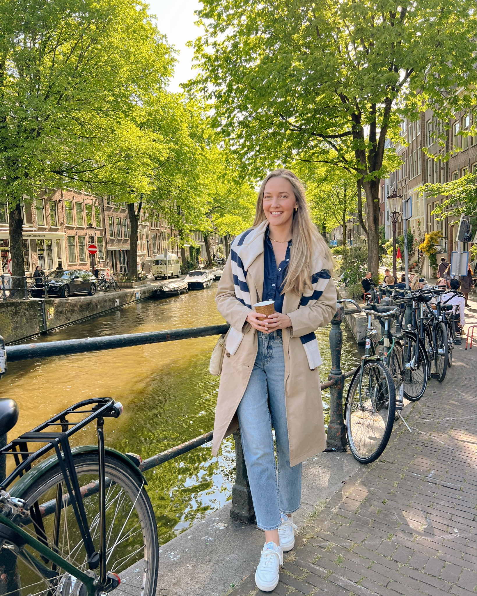 The quintessential Amsterdam outfit ☕️ Trench coat, button down, pullover, jeans, and comfy sneakers. 

#LTKSeasonal #LTKStyleTip #LTKTravel