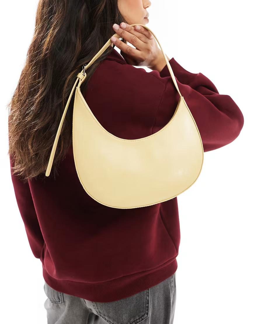 ASOS DESIGN asymmetric scoop shoulder bag with buckle detail in buttermilk-Yellow | ASOS (Global)
