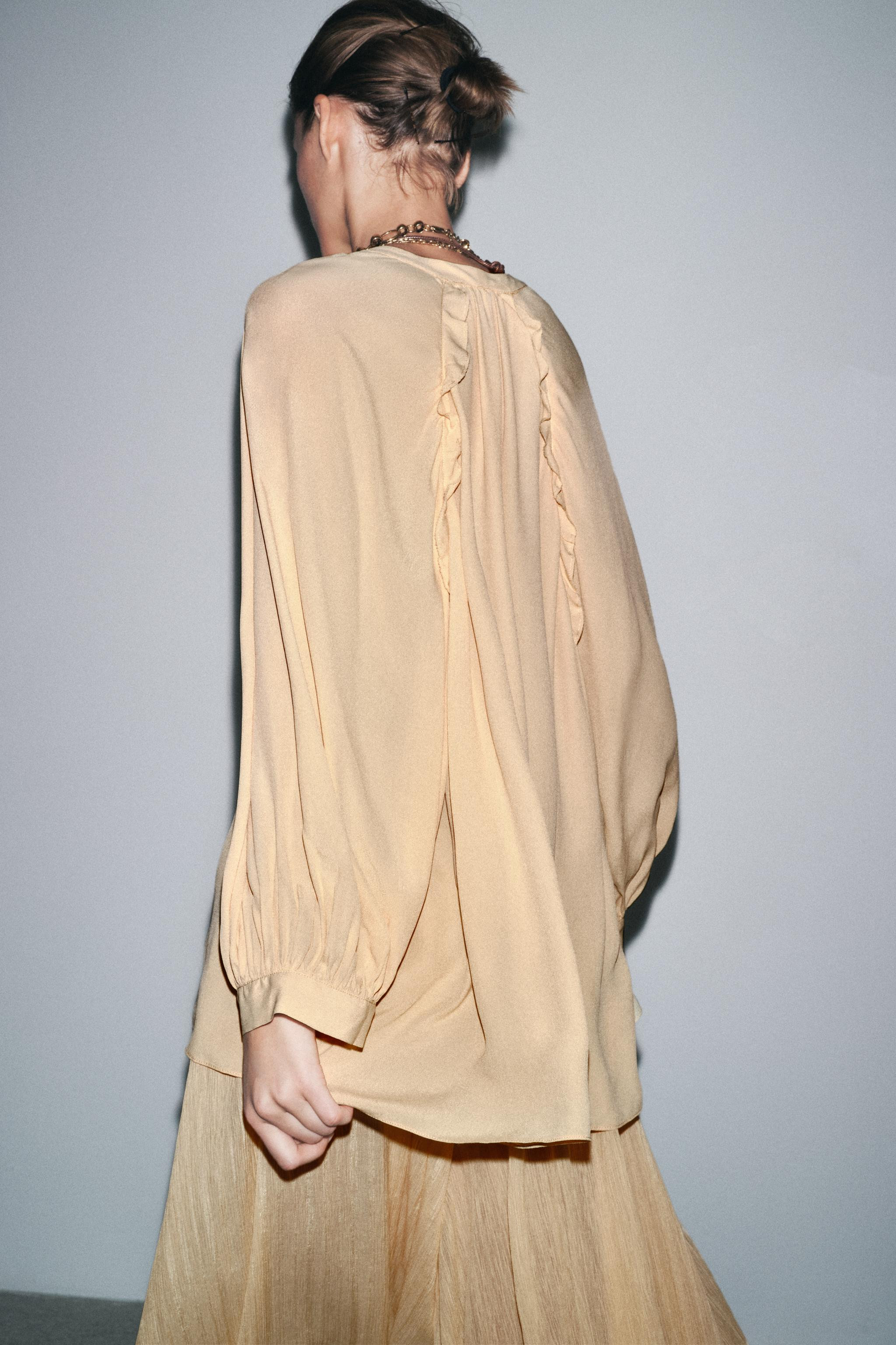 ZARA WOMAN COLLECTIONFlowy viscose shirt. V-neck and long sleeves with cuffs. Pleated detail. Asy... | Zara US