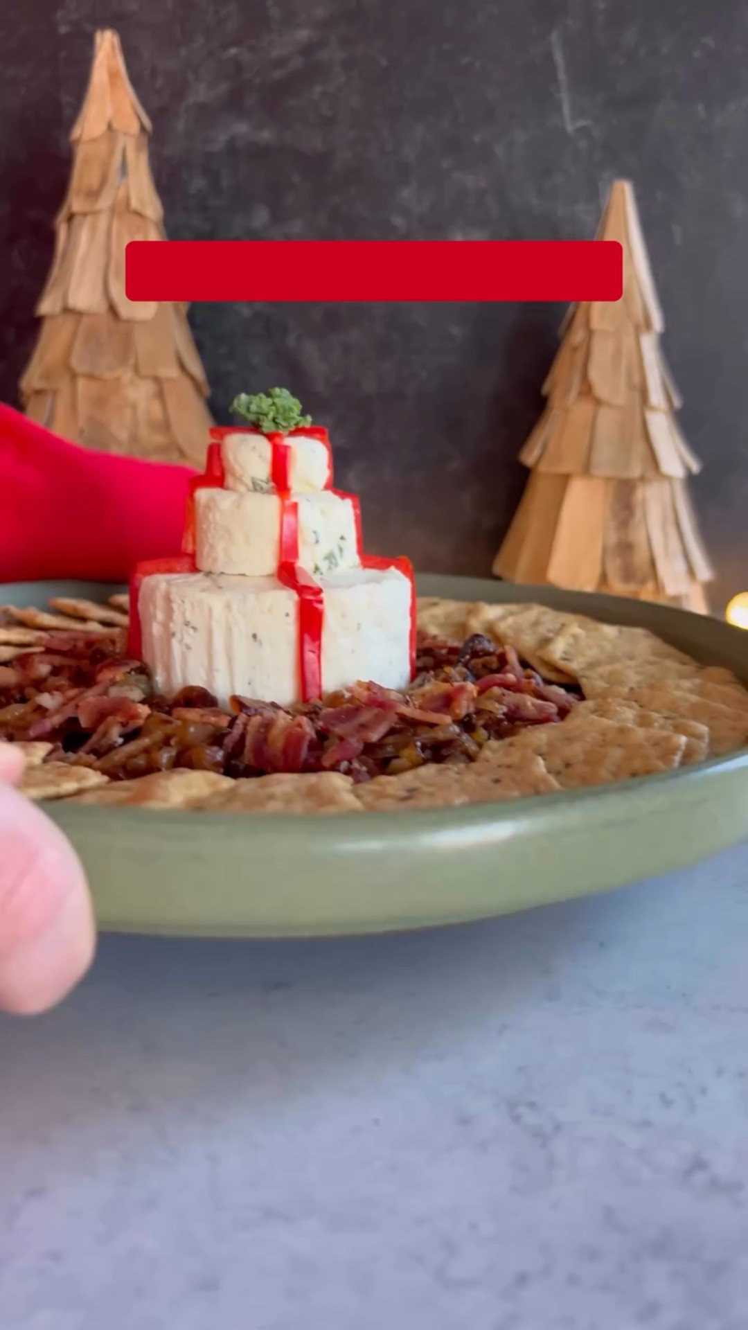 Appetizers that Sleigh, Episode 2

How cute is this cheeseball present for the holidays?! Dazzle your guests or take to your next party!

Comment CUTTER and I’ll send you the link to the cutters I used to cut into the Boursin cheese puck.

*Per Meta, must be following me first for the link to come through. Make sure to check your request/hidden messages folders.

Ingredients:
2 garlic Boursin cheese packages 
2 large white onions
4-6 slices cooked, chopped bacon
Extra virgin olive oil
1 T butter
Salt
Red bell pepper (for ribbon)
Kale (for bow)

Instructions:
Place 1 Boursin puck in the freezer for at least 30 minutes. After freezing, cut in half so you have 2 even pieces. Using 2 different sized cookie cutters, cut each into smaller circles.

Assemble your present. Stack using one whole puck as the base. Cut red bell pepper into thin strips for the ribbon and add to each layer. Top with kale for the bow.

Add caramelized onions around the base of the present. Top with bacon and enjoy! Serve with crackers or baguette and enjoy!

Follow me @thechicishchick for more holiday content!

#appetizersthatsleigh #holidayappetizers #holidayrecipes