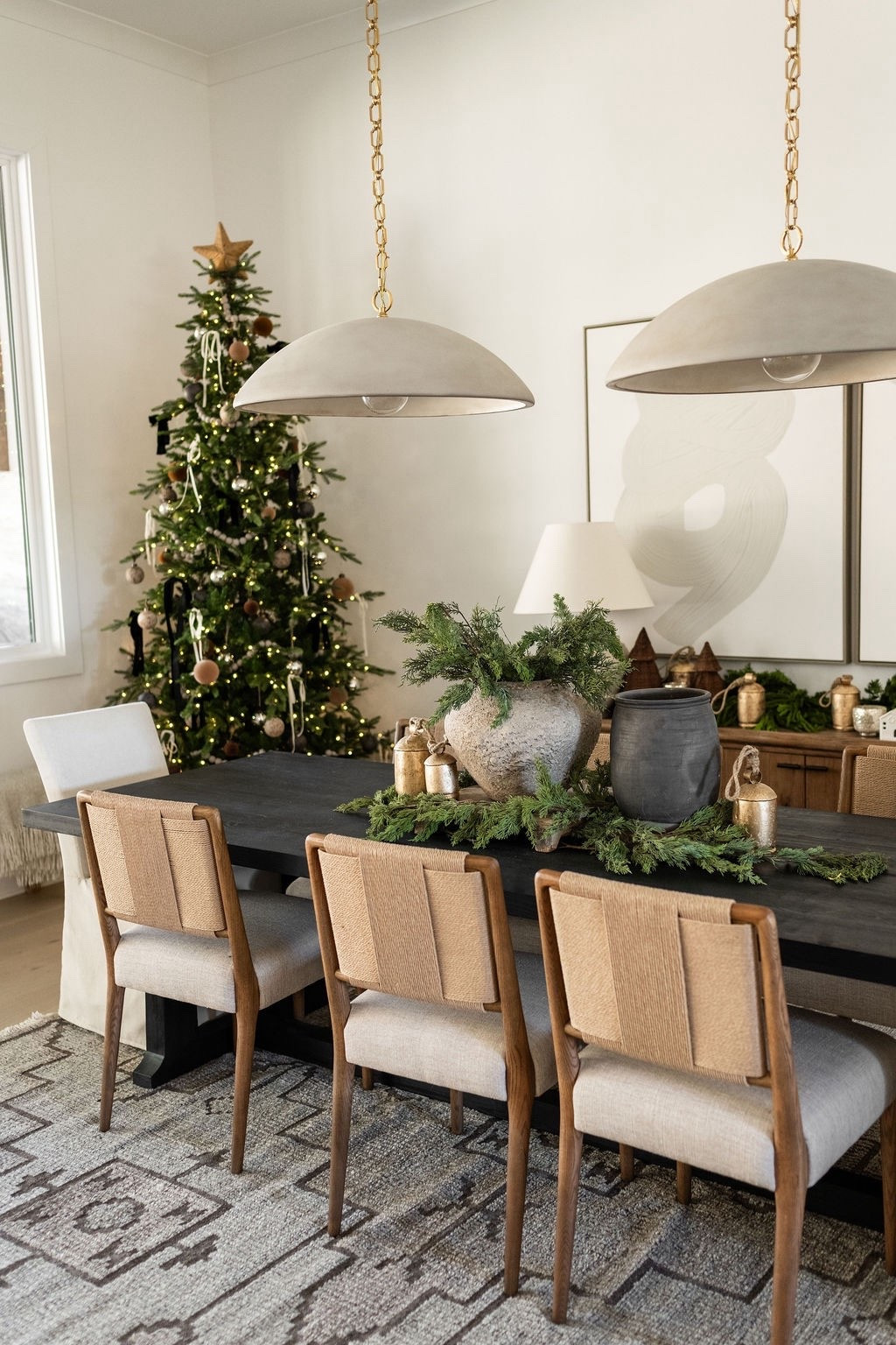 A dreamy Christmas dining room moment 🤍🎄 Layered neutral holiday decor, fresh evergreen branches, stone vases, gold bells, and a softly lit Christmas tree make this space feel warm and inviting. Perfect inspo for Christmas dining room styling, neutral Christmas decorating, modern classic holiday home decor, LTK holiday home finds, and winter tablescape ideas.

#LTKHome #LTKSeasonal #LTKHoliday