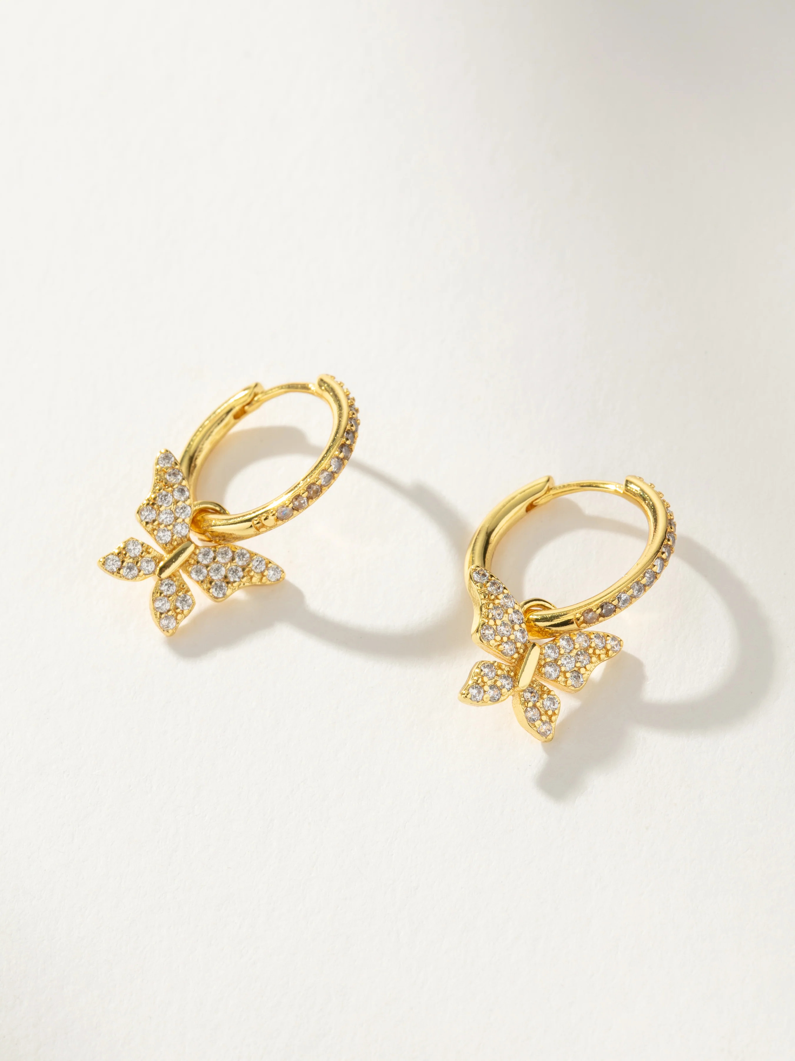 Pavé Butterfly Charm Huggie Earrings 2.0 in Gold | Uncommon James | Uncommon James