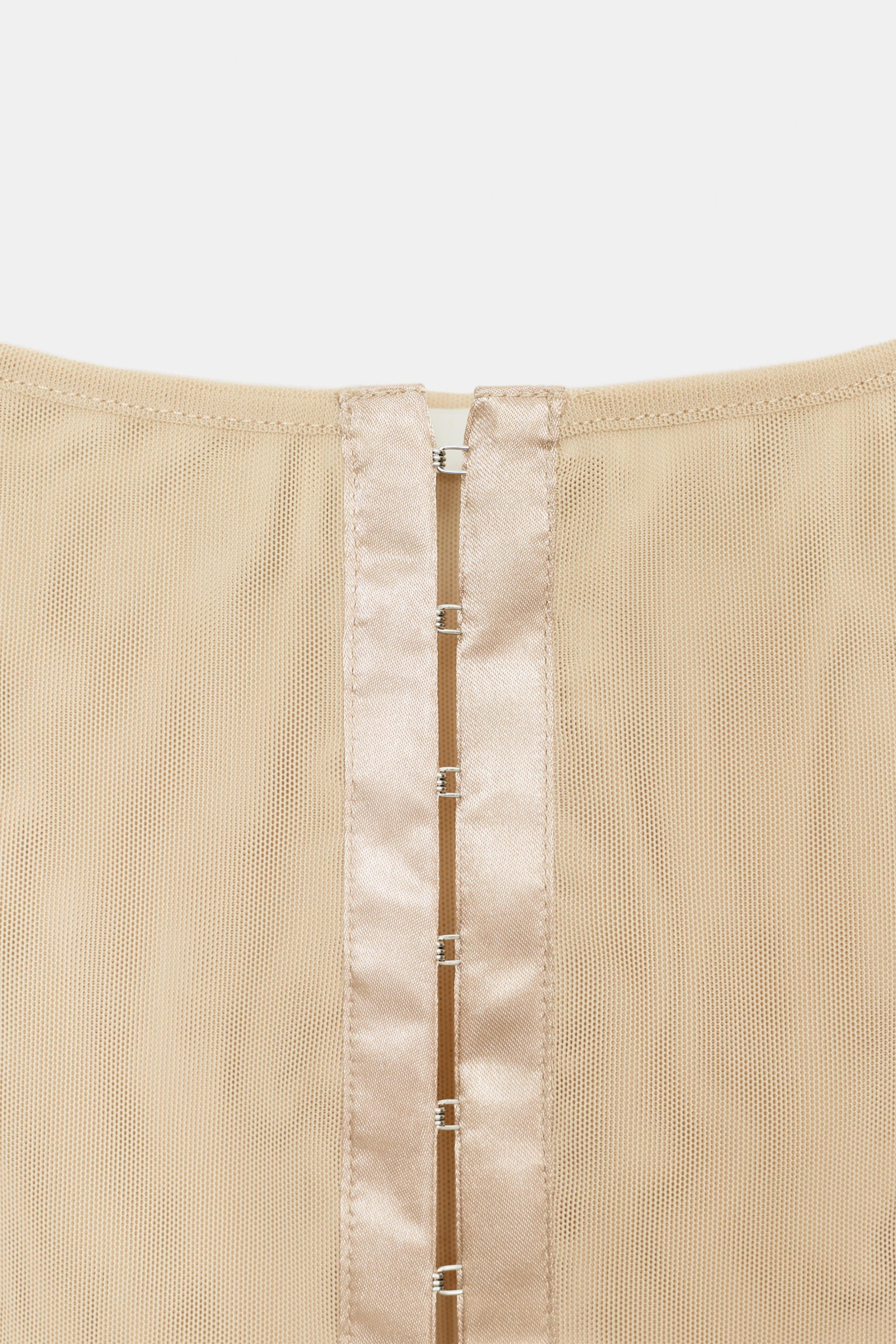 Top crafted from semi-sheer fabric. Featuring a round neckline and wide straps. Finished with ton... | Zara US