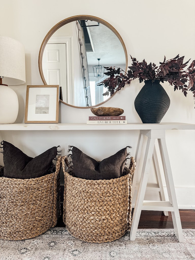 Neutral, timeless, and elevated ✨ This entryway setup is proof that less really is more. I styled this console with woven baskets for hidden storage (hello, cozy throw pillows 👋), a sculptural lamp, and a large round mirror to bounce light and open up the space. The black vase with moody faux stems adds the perfect seasonal contrast 🤍 Tap to shop this classic look—everything is linked for you!

#LTKhome #entrywaydecor #neutralhome #homestyling #consoletabledecor #organicmodern #roundmirror #basketswithstyle #vasegoals #fauxflorals 

 

#LTKHome #LTKStyleTip #LTKFamily