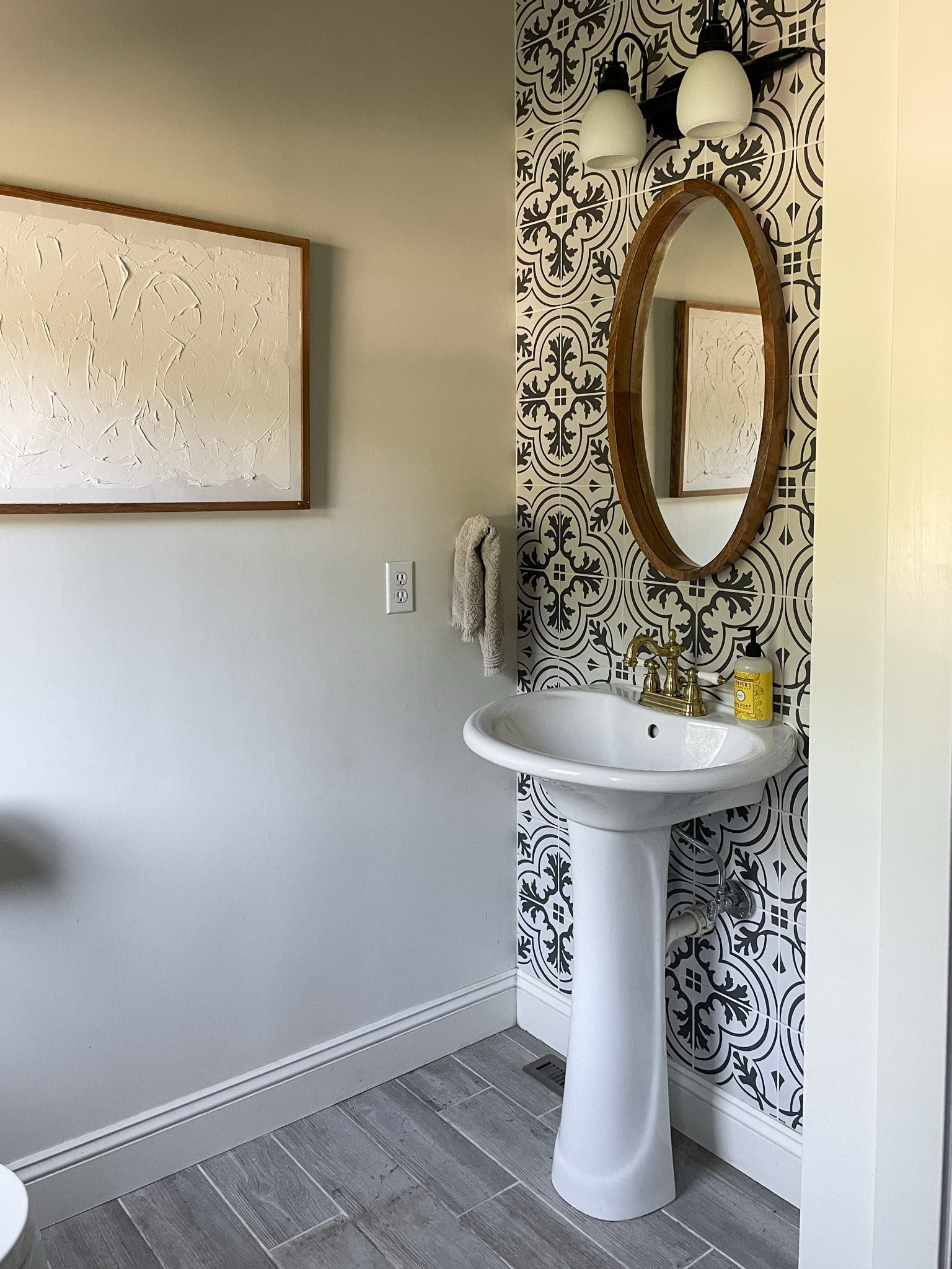 Our main laundry room has withstood the test of time.  I still love the tile on the wall, mirror and pedestal sink.  

Bathroom.  Powder room.  

#LTKHome #LTKFamily