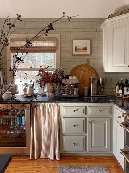 Things I love about this view…👇🏻

The asymmetrical mat in my thrifted frame (artwork is @linagordievskyart). 

The veining in our soapstone counters. 

The sunlight. ✨

The styled but not perfectly put-together coffee & wine setup. I can remember just a couple years ago feeling like I needed to move all those wine bottles and regular coffee maker out of the way for pictures because they aren’t as “pretty”. Do I still straighten up a bit before shooting? Of course but this is our everyday setup and it’s real. 

PS. Our runner, coffee maker, and drink fridge are on sale!

#farmhousedialfano #kitchendesign #tiledesign #fireclaytile #vintagehomedecor #greencabinets 

#LTKsalealert #LTKCyberweek #LTKhome