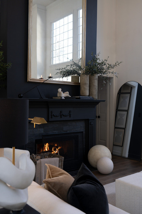 I am actually screaming this fireplace styling turned out SO GOOD!! Modern black mantel, oversized mirror, layered greenery, sculptural decor and cozy fire glow creating the dream luxury living room vibe. The contrast with the soft neutral furniture makes everything feel warm, elevated and designer level stunning. I never want to leave this room!!  

 #LTKSeasonal #LTKHome #LTKSaleAlert