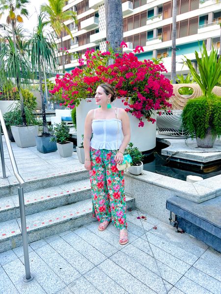 Tropical resort outfit! Floral flowy pants with a white smocked crop top, Palm Beach Sandals ans tassel earrings! 

#LTKstyletip #LTKtravel