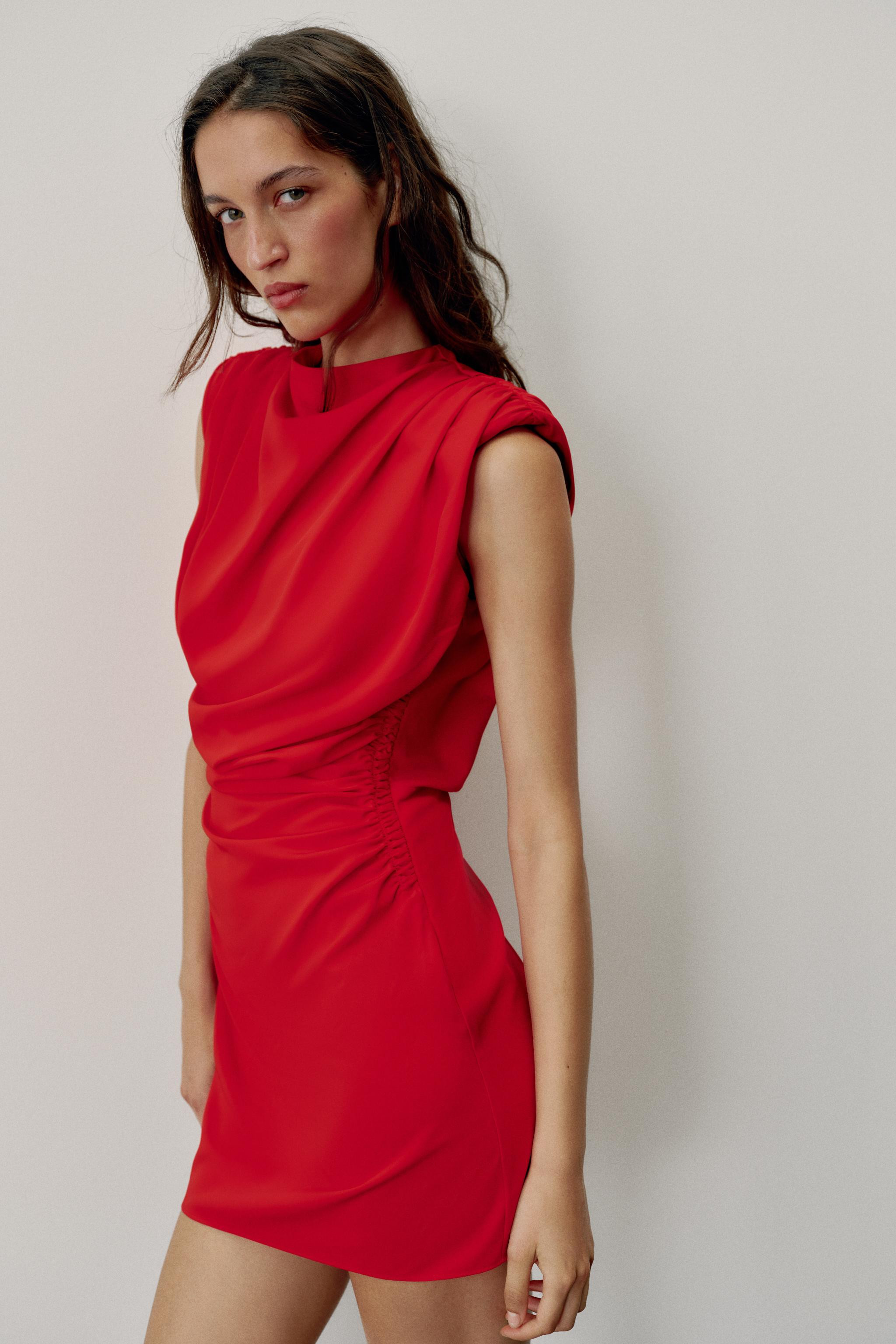 Short round-neck, sleeveless dress with shoulder pads. Back opening and gathered finishes. Side h... | Zara US