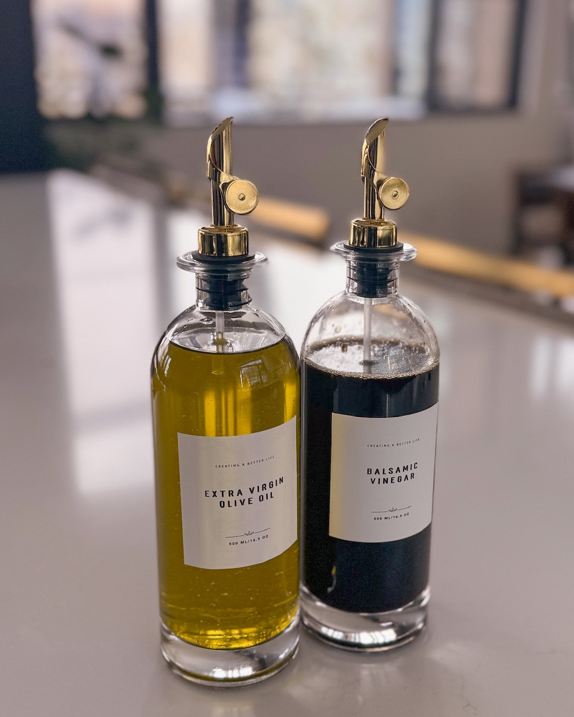 This $39.99 set of 2 super pretty reusable glass dispenser bottles is a must-have!!! I have these in multiple sizes for all my oils and vinegars, but these can also store maple syrup, coffee syrups, soy sauce, cooking wines, and more! They come with pre-made labels, which are very modern and clean. The labels are reusable, oil-proof, and water-proof so you don't have to worry about them looking dingy with use. The pour tops are also food-grade with stainless steel plating. They're simply AH-MAZING! 

Be sure to follow me @busbeestyle for more viral Amazon product reviews! 

~Erin xo 

#LTKHome #LTKFindsUnder50