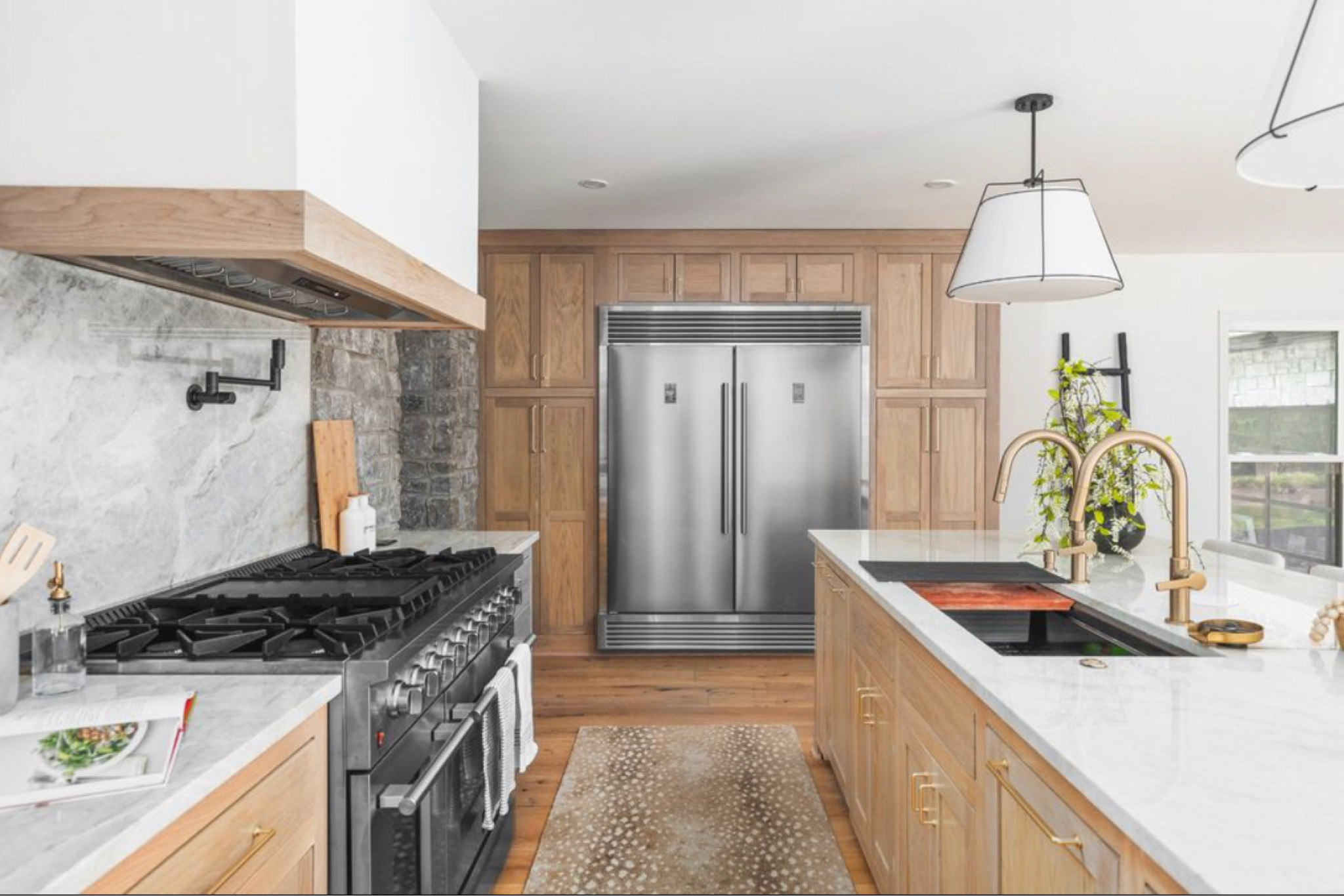 Shop our kitchen! These are custom white oak kitchen cabinets with Taj Mahal quartzite countertops. The wall color is Sherwin Williams pure white. The backsplash stone is gray Tennessee limestone. I absolutely love these island lights, for an 8’ island these are perfect sizing! 
The 4 bar stools are a set and are a STEAL! 
For professional grade appliances this 48” fridge and 48” gas range are very budget friendly! 
I love the large sink with double faucets! We also have double 18” dishwashers that are panel ready Zline! I would recommend doing 2 24” however, the 18” are just to small. I love the pot filler and all the things about our kitchen! 

#LTKU #LTKHome #LTKStyleTip