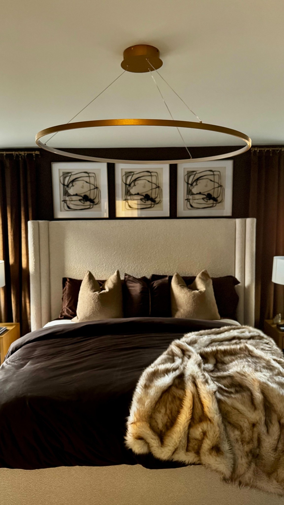 My clients envisioned a luxury oasis, blending rich textures and a monochromatic palette of brown, taupe, and gold. From bouclé and satin fabrics to custom wall paneling, every detail adds depth and sophistication 😍✨ and to see how the natural lighting captures every detail is BREATH TAKING 😮‍💨. 
Gold accents and plush layers complete this high-end retreat. Shout out to @neighborhoodstampedrenovations  once again for helping to bring this room to life with adding texture and paint (Timber Wolf by @behrpaint ) this was just the right touch ✨😍. Lastly amazing shoutout to @mccoys_moving_company and @meridianfurniture  for these gorgeous nightstands and boucle and gold bed frame😍

 #LuxuryInteriors #MonochromeDesign #HighEndLiving #ModernElegance #TexturedDesign #SophisticatedStyle #DreamBedroom  #signaturesbykay #fyp

#LTKHome #LTKSaleAlert #LTKFamily