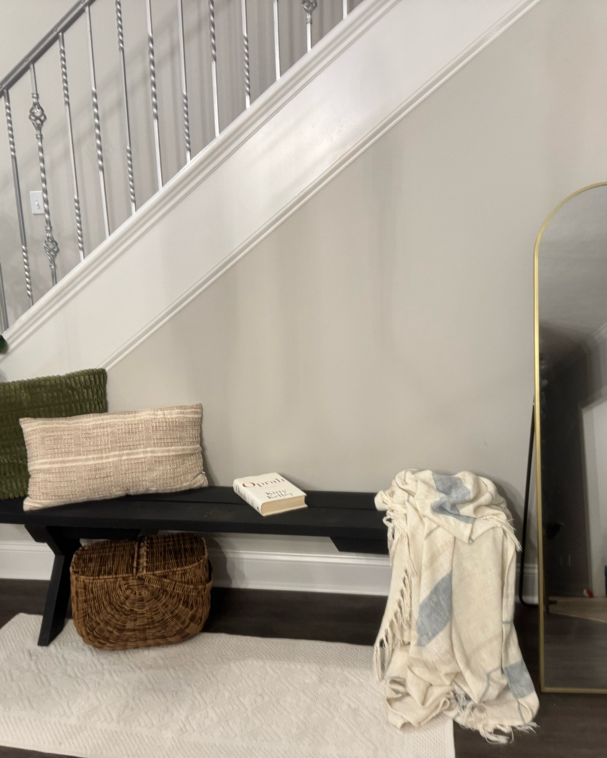 Estate sale finds are honestly undefeated 🖤

Found this wooden bench for a fraction of what similar pieces cost retail, gave it a good wash with soap + bleach, let it dry in the sun, and now it has a whole new life indoors under the stairwell as a cozy little reading nook + shoe drop zone.

I almost spray painted it… but after sitting it here, I decided to keep the black finish for now. Sometimes older pieces already have the character you’re looking for ✨

I’ll look for similar benches on Amazon to link for you guys, but don’t underestimate estate sales, garage sales, or thrift finds. Some of the best home pieces are hidden under a little dust and pollen 🌿

A little DIY can save you hundreds:
• spray paint
• new cushions
• light sanding
• styling with pillows/books/baskets

Home decor doesn’t always have to be expensive to feel beautiful and elevated.#EstateSaleFinds #HomeDecorIdeas #CozyCorner #ReadingNook #DIYHomeDecor #SlowLiving #SuburbanLiving #HomeStyling #BudgetDecor #LTKFinds #AmazonHome #NeutralHomeDecor #VintageStyle #Homemaking

#LTKHome #LTKSaleAlert #LTKHome #LTKvlog