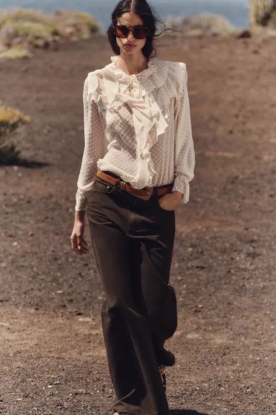 Semi-sheer round neck blouse with ruffles and drawstring. Long sleeves with elastic cuffs and ruf... | Zara US