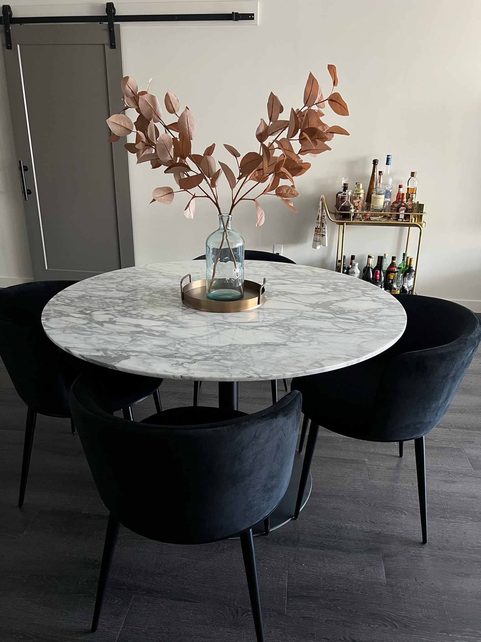 Fall home decor 
Bar cart 
Marble pedestal dining table  
Wing back black velvet chairs   
Faux stems 
Clear, glass vase  
Round Brass tray  


#LTKstyletip #LTKSeasonal #LTKhome