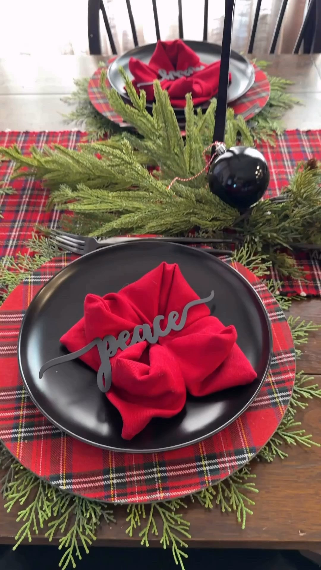 Festive Christmas table inspiration and fun napkin fold tartan table runner, tartan chargers, black dinner plates, pine placemats 

#LTKSeasonal #LTKHoliday #LTKHome