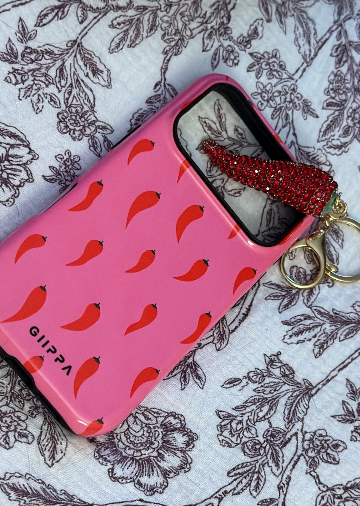 If you’ve followed me for a while, you already know I have a slight obsession with chili peppers. 🌶️😂 I even have one tattooed on me, so when I found this pink chili pepper phone case, I immediately knew I needed it. The pink and red color combination is one of my all-time favorites, and it adds the perfect pop of color while still matching my everyday style.

I couldn’t stop there, so I upgraded my car keys with this rhinestone chili pepper keychain too. It’s such a fun little accessory that makes something I use every single day feel a little more personal. The red rhinestones add the perfect amount of sparkle, and honestly… I clipped it onto my handbag the other day as a bag charm, and it looked so cute. I love finding accessories that can do double duty, and this one works perfectly as both a keychain and a purse charm.

If you’re someone who loves adding personality to your everyday essentials, these are such fun finds. They’re practical, unique, and make your phone, keys, or favorite handbag feel a little less basic. I linked both because they’ve quickly become two of my favorite accessories, and I know I’ll be using them year-round. ❤️🌶️✨

#LTKstorytime #LTKU #LTKSaleAlert