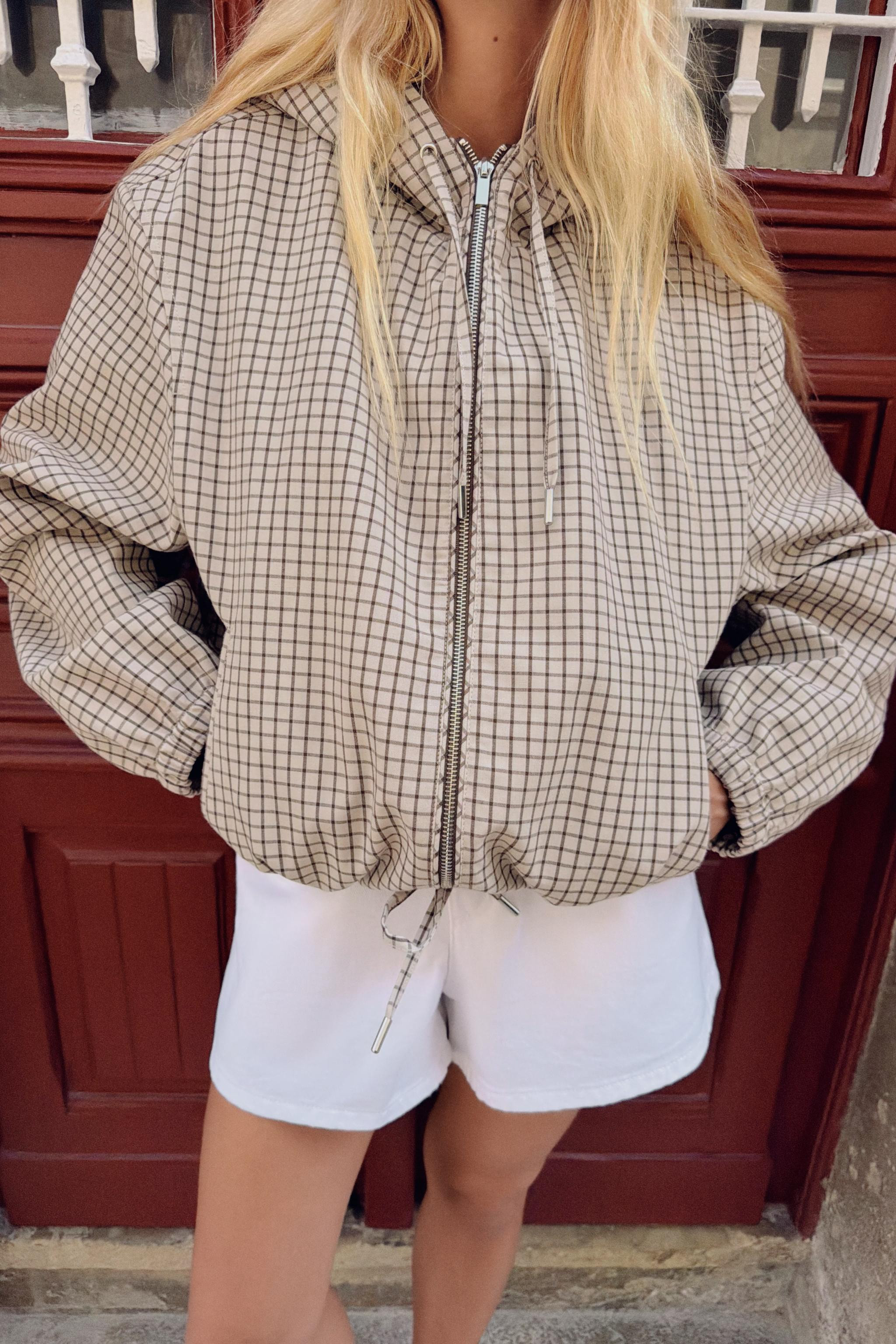 Jacket featuring an adjustable drawstring hood and long sleeves with elastic cuffs. Front double-... | Zara UK