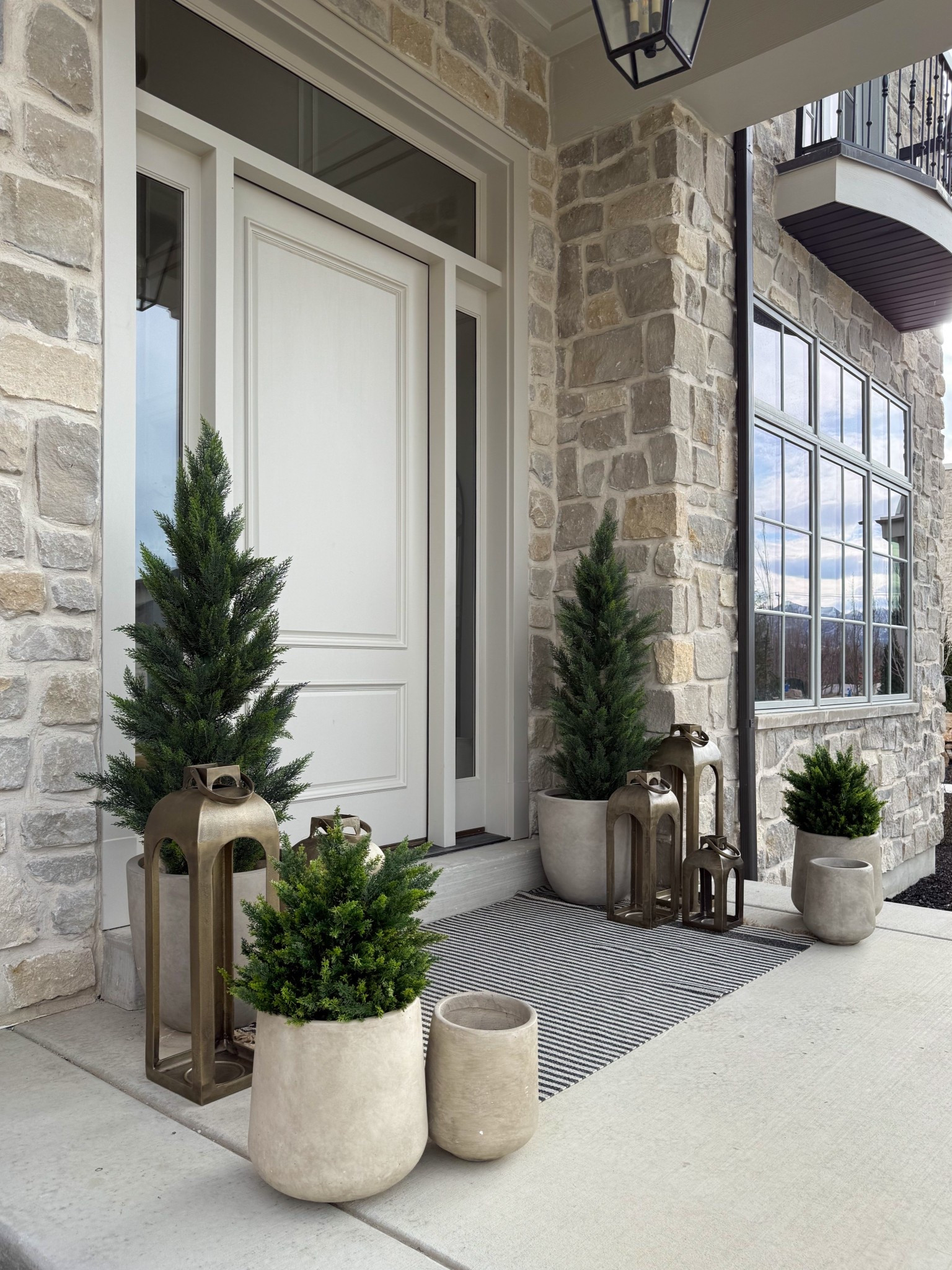 Playing around with my front porch styling for a spring refresh in my outdoor space. 

I need some florals for the smaller concrete planters, but I think I like all the various planter sizes and the new cast aluminum lanterns.

And as always, my faux trees and outdoor rug are a favorite!

#frontporch #amazon #target

Front porch styling, spring styling, spring refresh, outdoor styling, outdoor spaces, concrete planters, Kante planters, faux cedar trees, faux outdoor shrubs, fake bushes, fake trees, spring porch, outdoor planters, decorative lanterns, target lanterns, tall lanterns, target home, Amazon home, Wayfair home decor, Wayfair home, spring decorating, elevated home design, 

#LTKHome #LTKStyleTip #LTKSeasonal