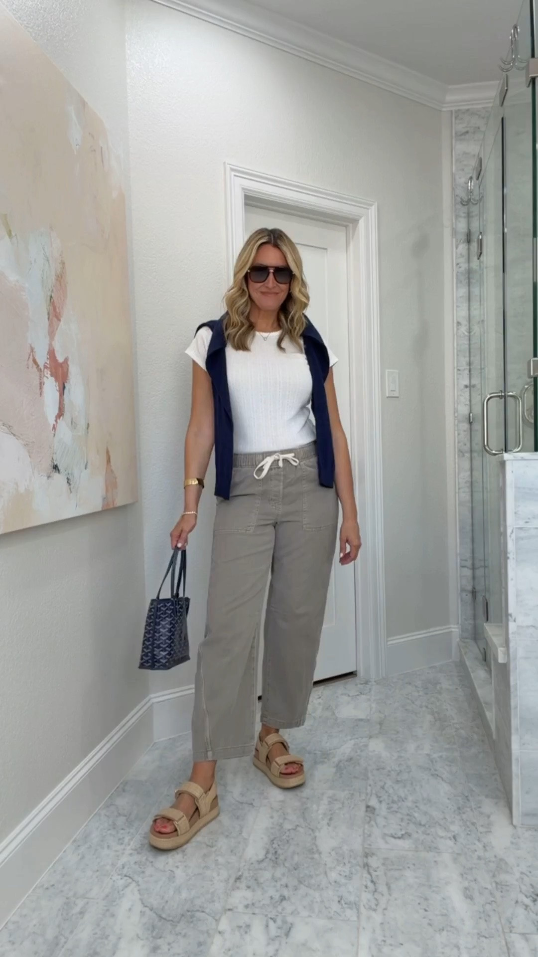 I wore this for a day when I wanted to be comfortable but still look pulled together. The soft white tee and relaxed utility pants keep the outfit easy, while the navy sweater over the shoulders adds a little structure and makes the neutral colors feel more finished.

Utility pants outfit, white tee, navy sweater, casual summer outfit, relaxed fit pants, neutral style, everyday outfit, comfortable fashion, transitional outfit, HauteandHumid

#LTKootd #LTKSeasonal #LTKOver40