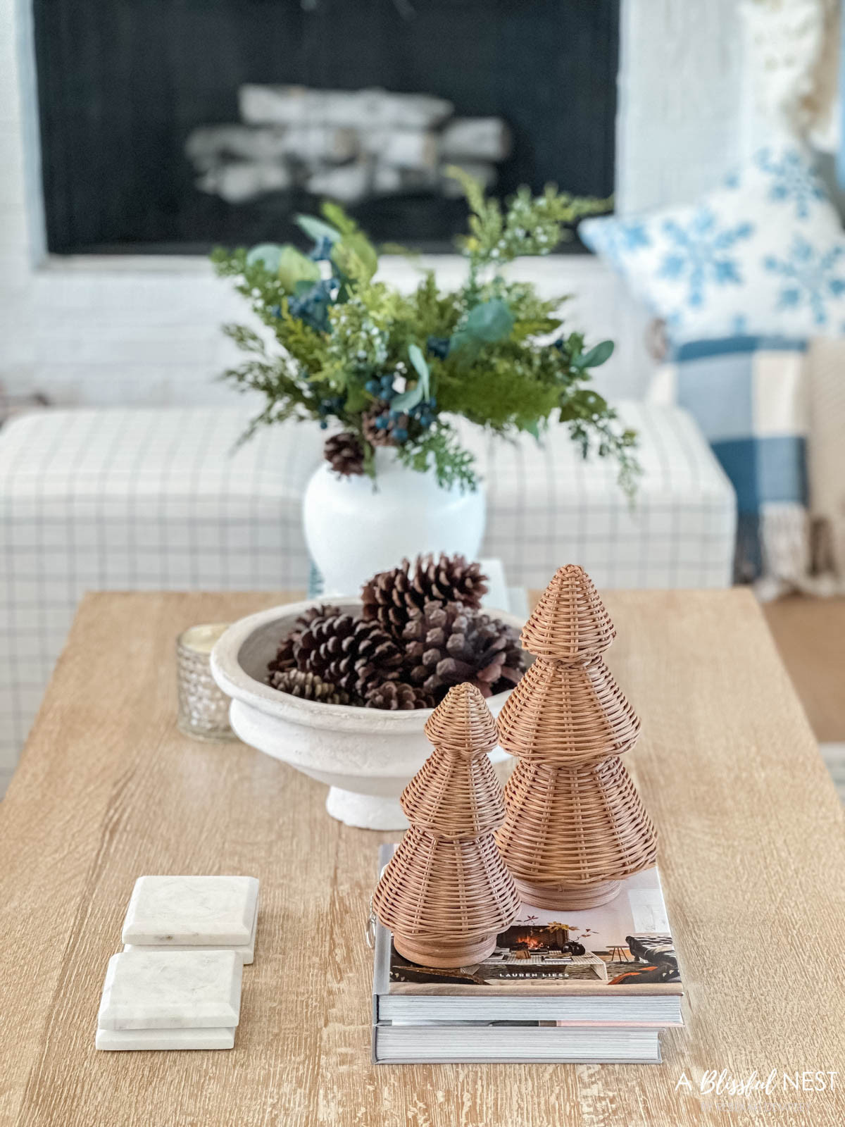 Pinecones and greenery make the easiest festive combo. Click to shop the look.
upholstered cube ottoman, natural pine cones, blueberry greenery picks, snowflakes pillow, woven Christmas cone tree, blue and white checkered throw blanket, scented candle 

 #LTKHoliday #LTKSeasonal #LTKHome