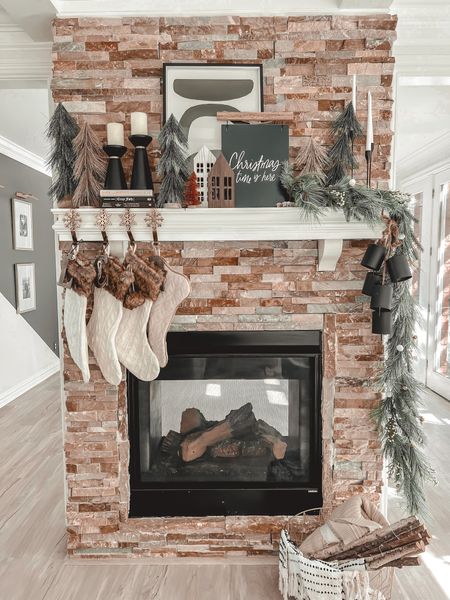 One side of my double sided fireplace ✨ includes a Christmas garland on sale from TARGET and some Christmas bells as accent. My favorite Christmas stockings also tagged! 

#LTKhome #LTKSeasonal #LTKHoliday