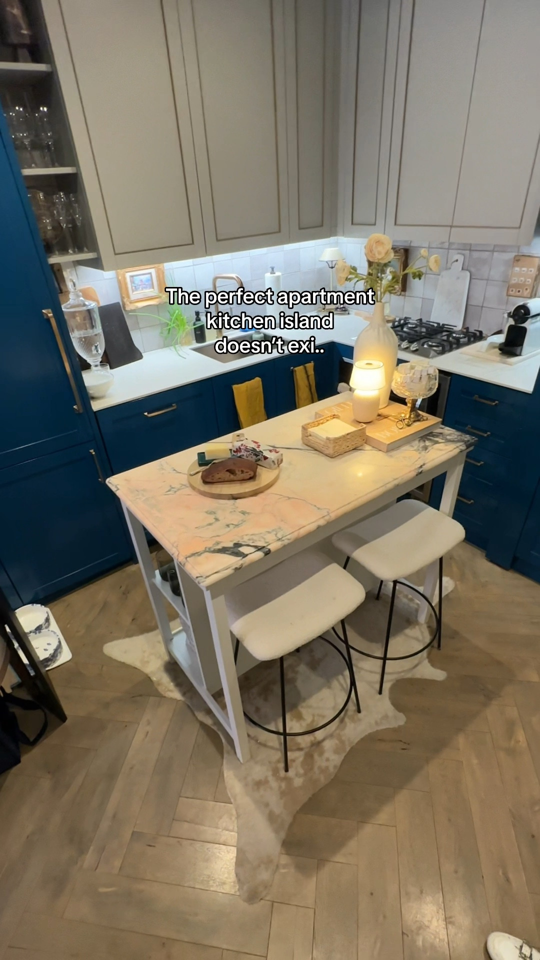 I found the perfect kitchen island for a small apartment. It has everything I needed: storage, pace for seating, wine rack and most importantly, a small footprint. The marble was added on top to elevate it even further  